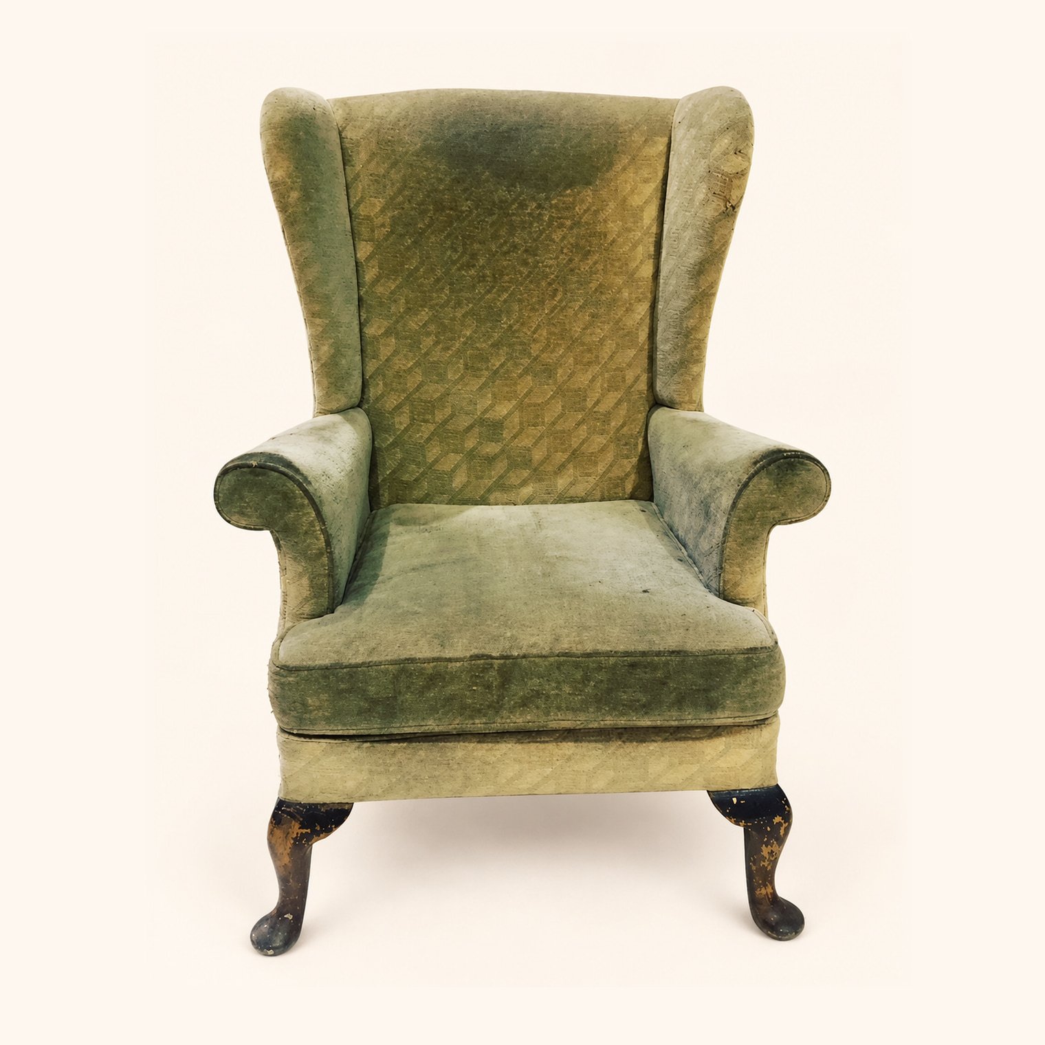 Parker Knoll Armchair in worn green upholstery before reupholstery.