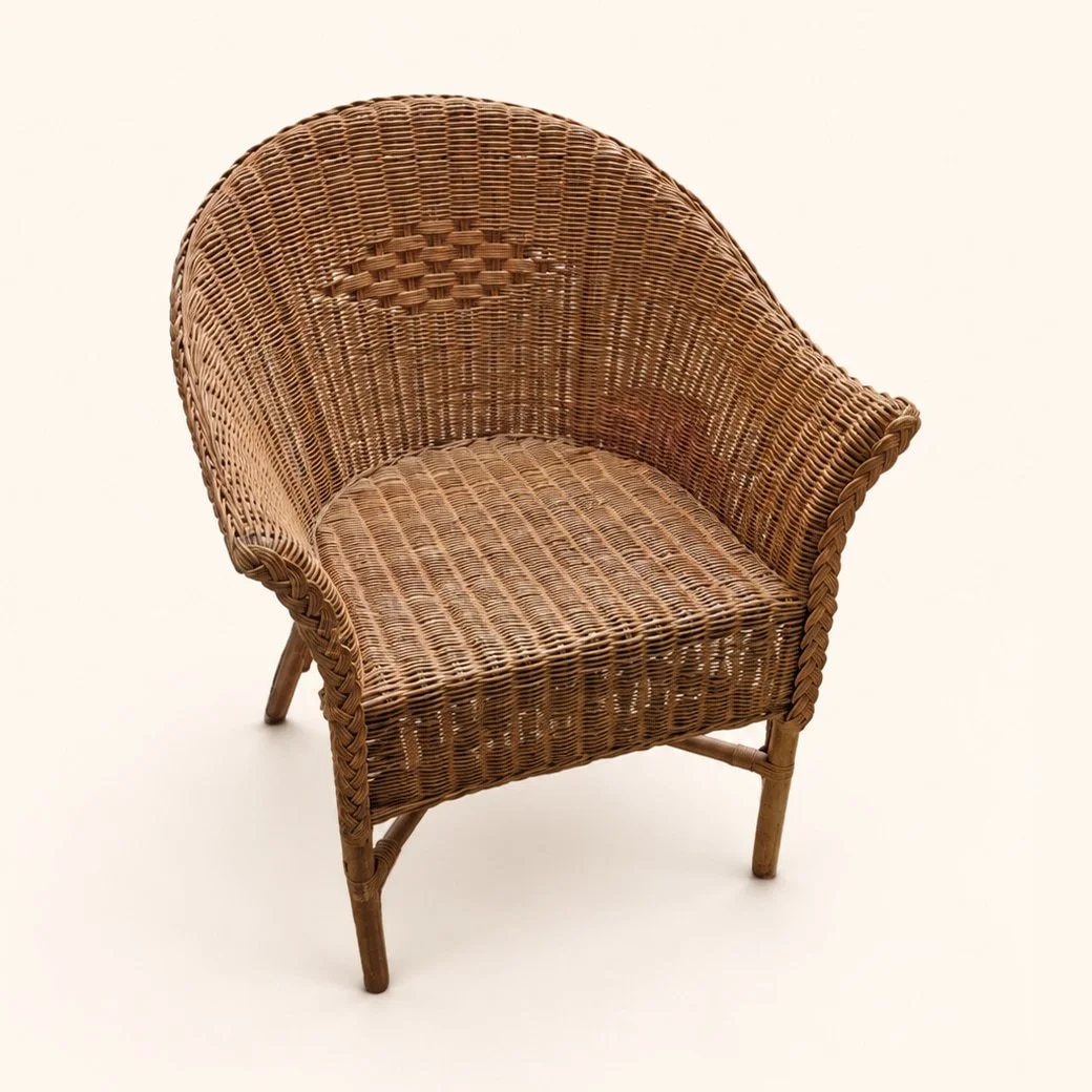 Wicker armchair with its original woven seat before a new upholstered cushion.