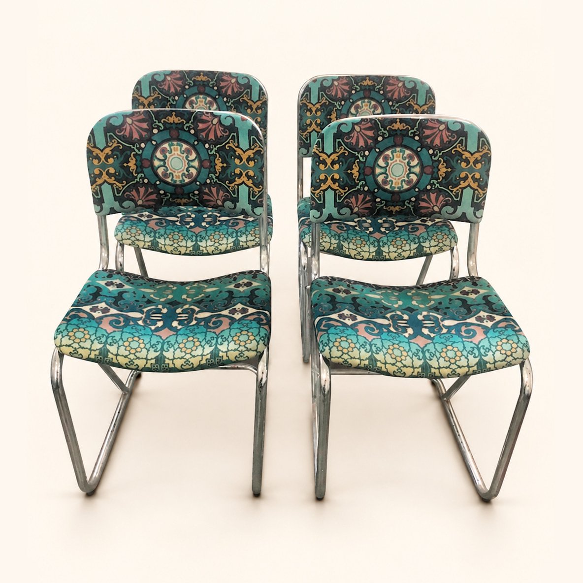 Set of chrome-frame chairs reupholstered in colourful patterned fabric.
