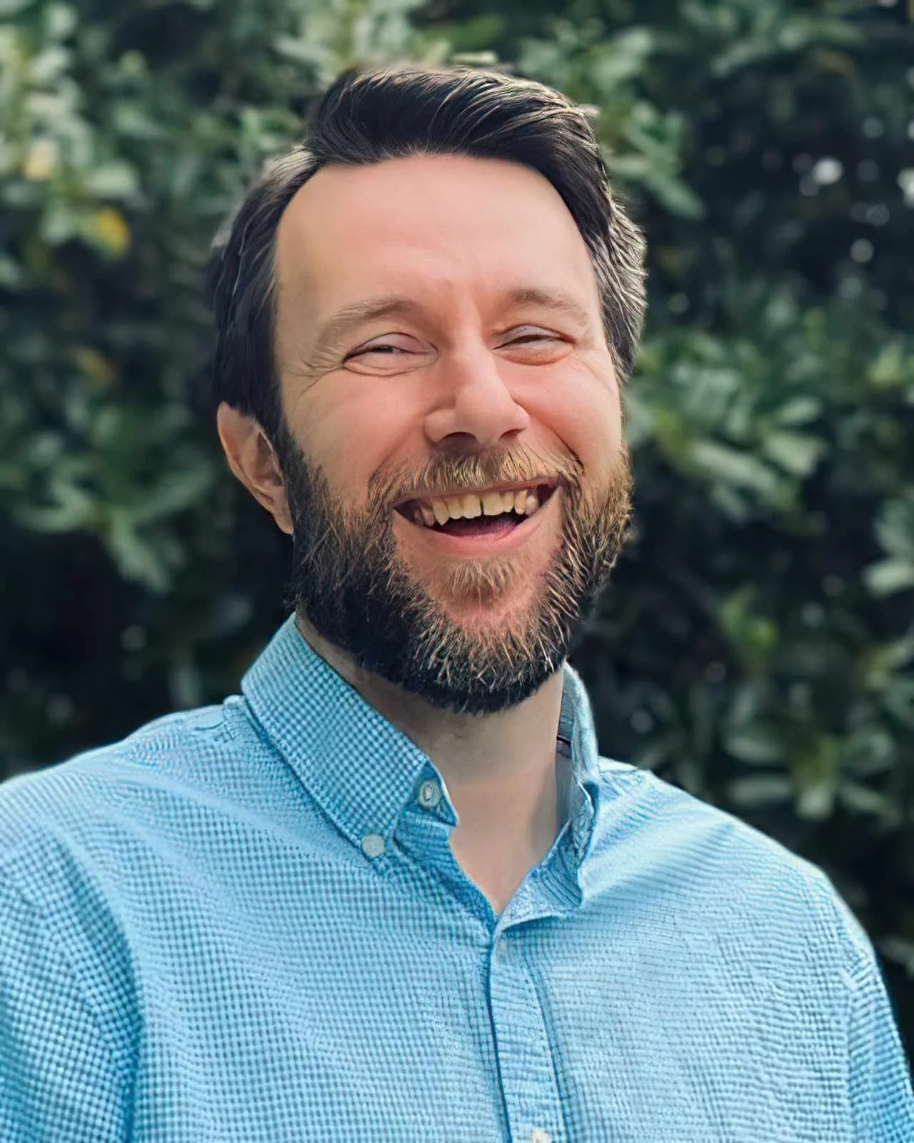 James Wise, LMFT, smiling outdoors in a light blue button-down shirt
