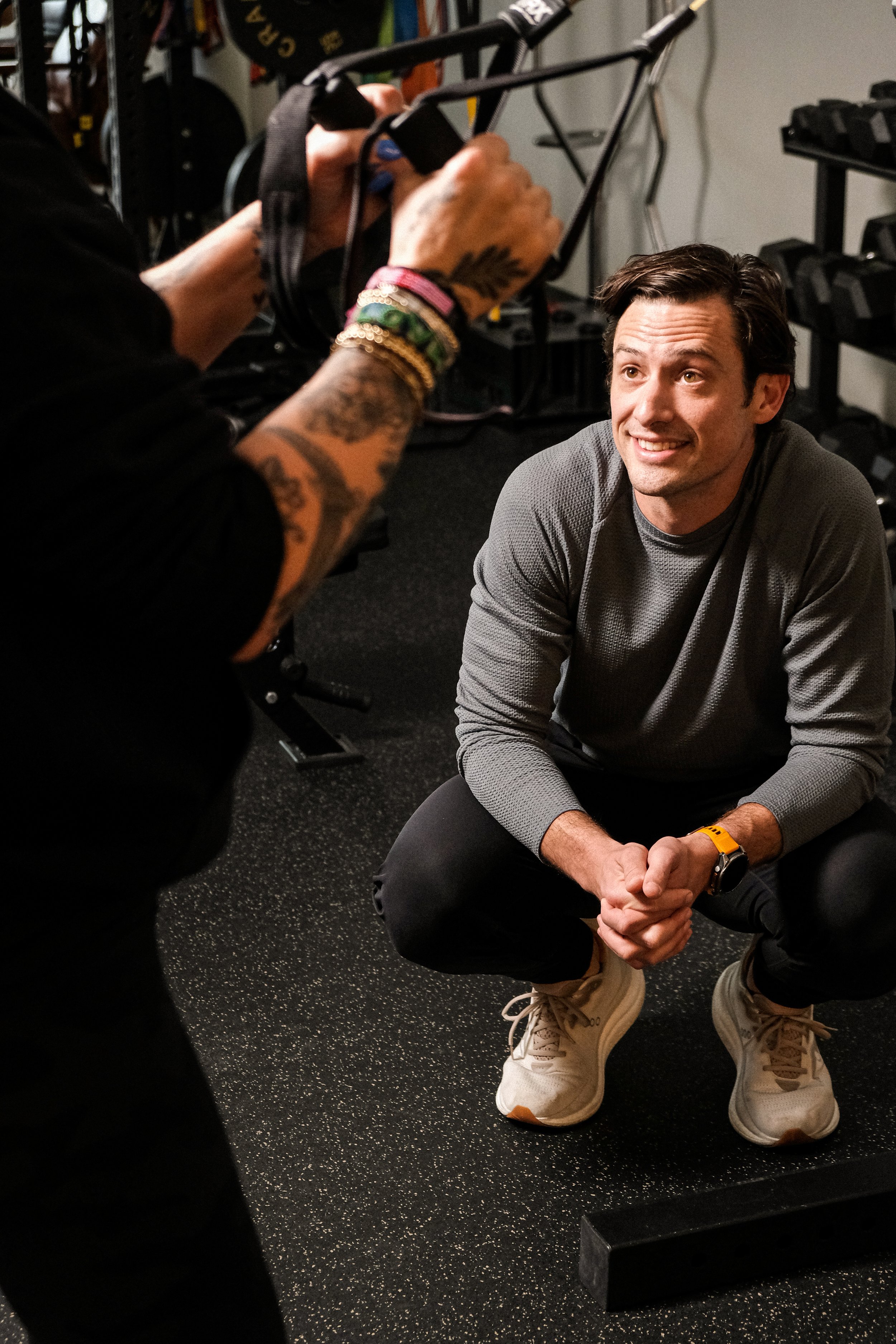 Nashville Physical Therapist, Chase Batty, crouches down while coaching his patient through an exercise.