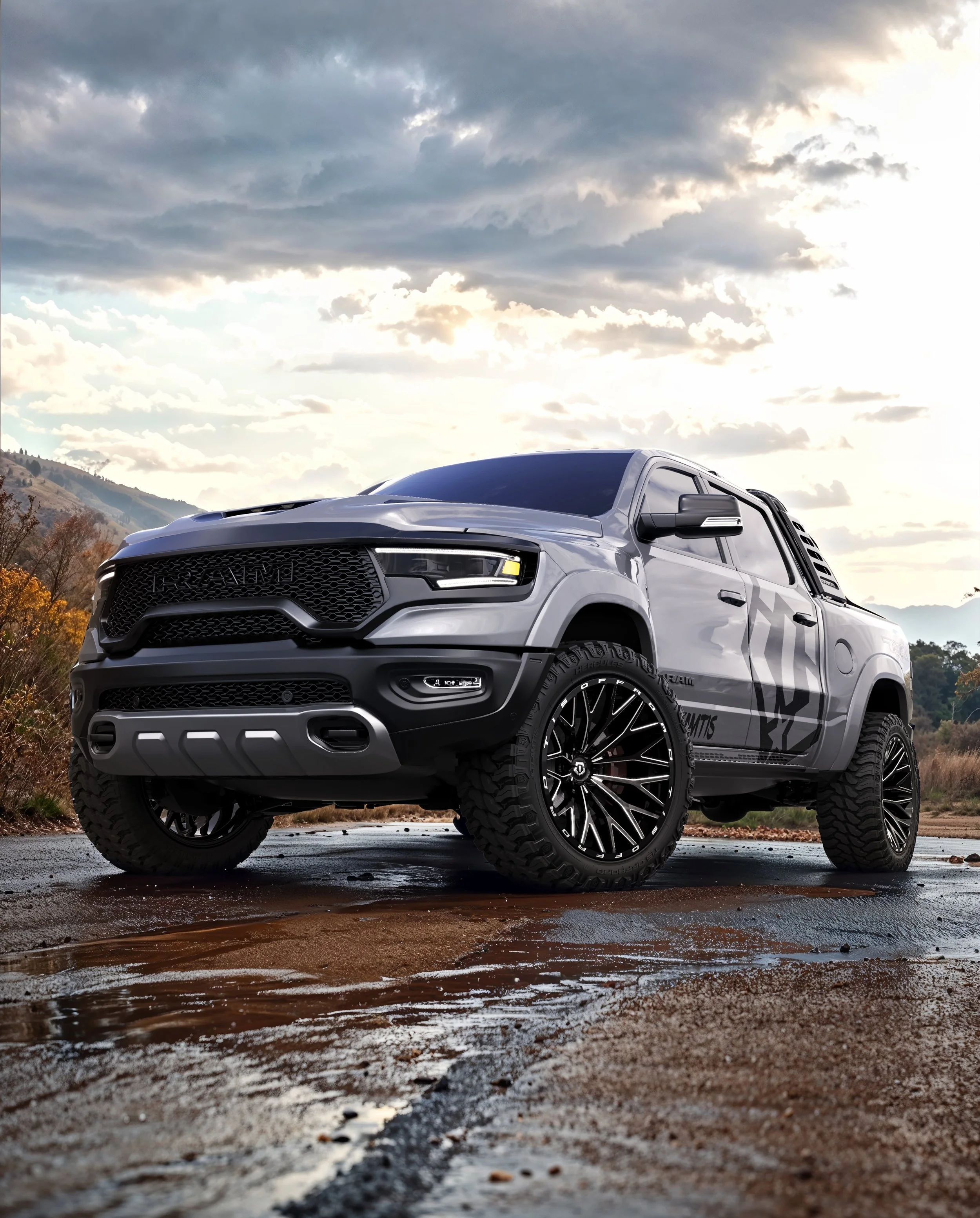 A silver off-road pickup truck parked on a wet, muddy surface with mountains and cloudy sky in the background.