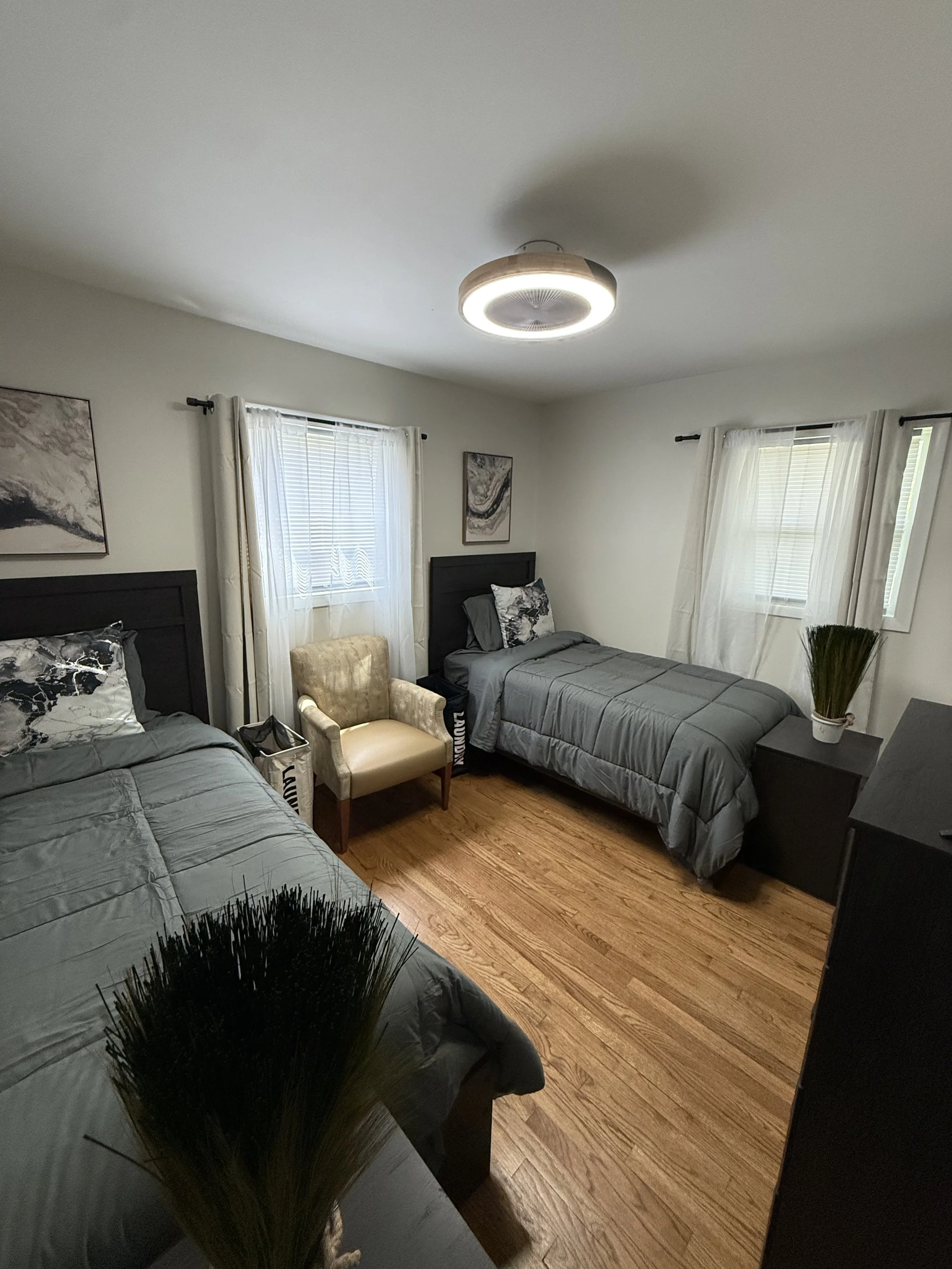 Bedroom with two beds and chair