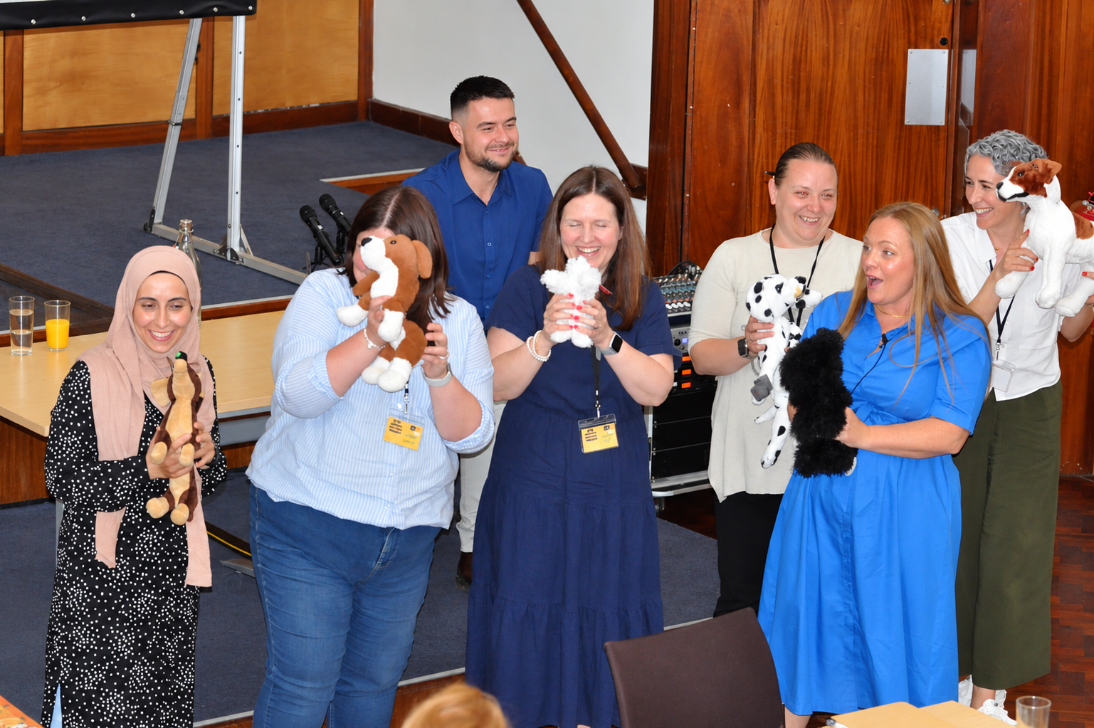 Early years practitioners holding puppets during an interactive in-person training workshop.