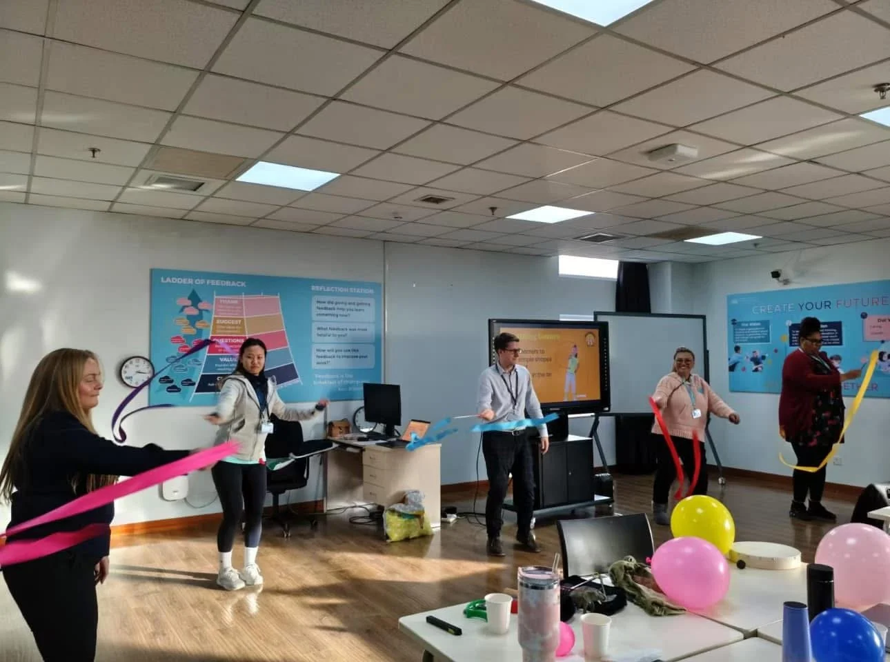 Teachers using ribbons and balloons during Getting Ready to Write training in Beijing.