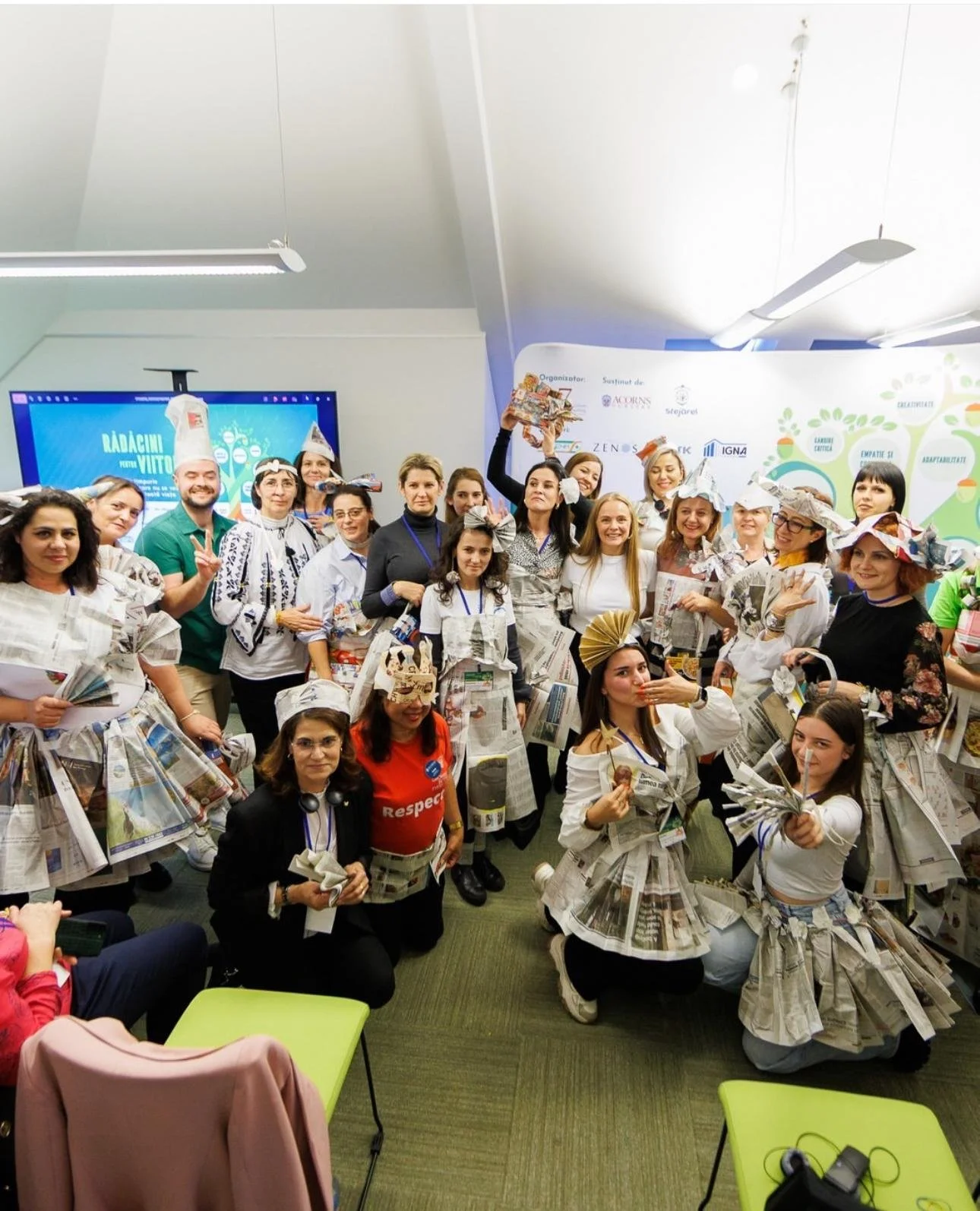 Practitioners wearing newspaper creations during a playful early years training activity.