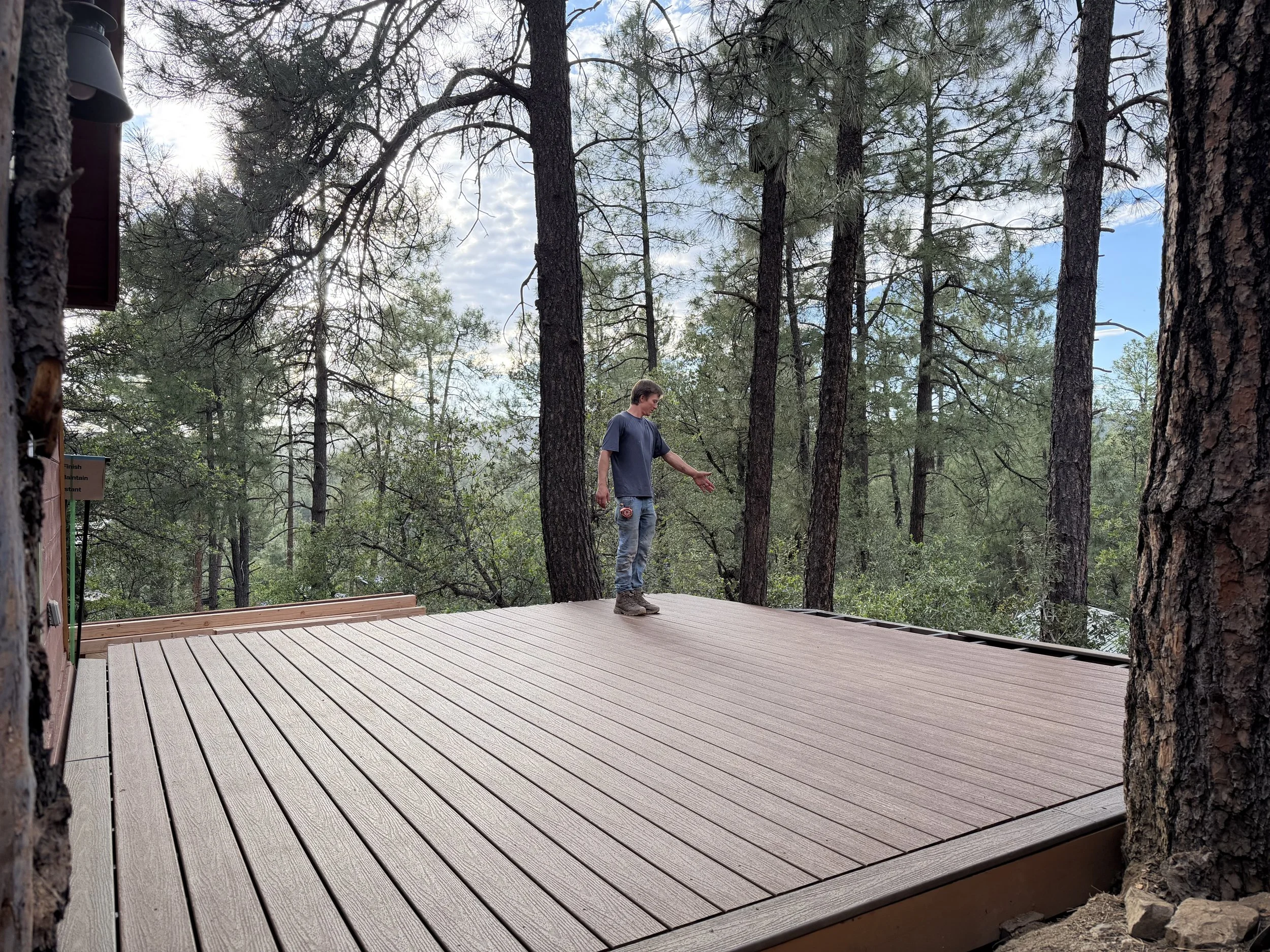 Jesse Stumpf standing on a newly built wood deck before railing installation in Prescott, Arizona.