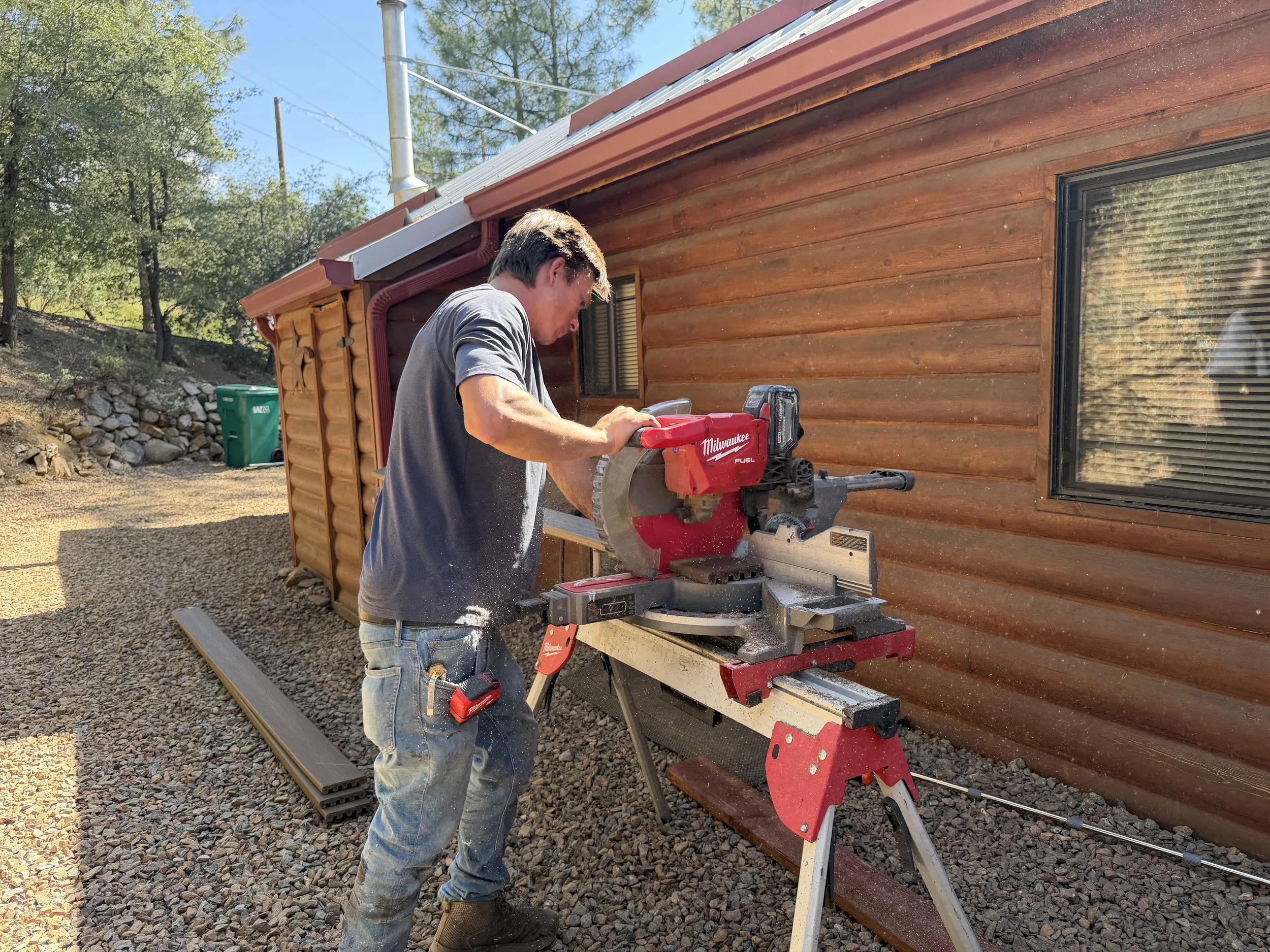 Cutting lumber for custom deck, stair, and railing construction during a Prescott, Arizona project.