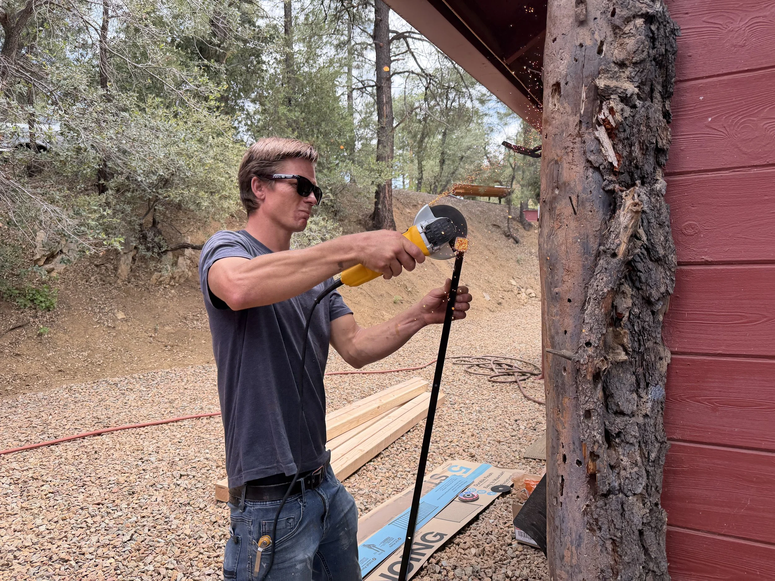 Cutting metal for a custom deck railing during a Prescott, Arizona deck construction project.