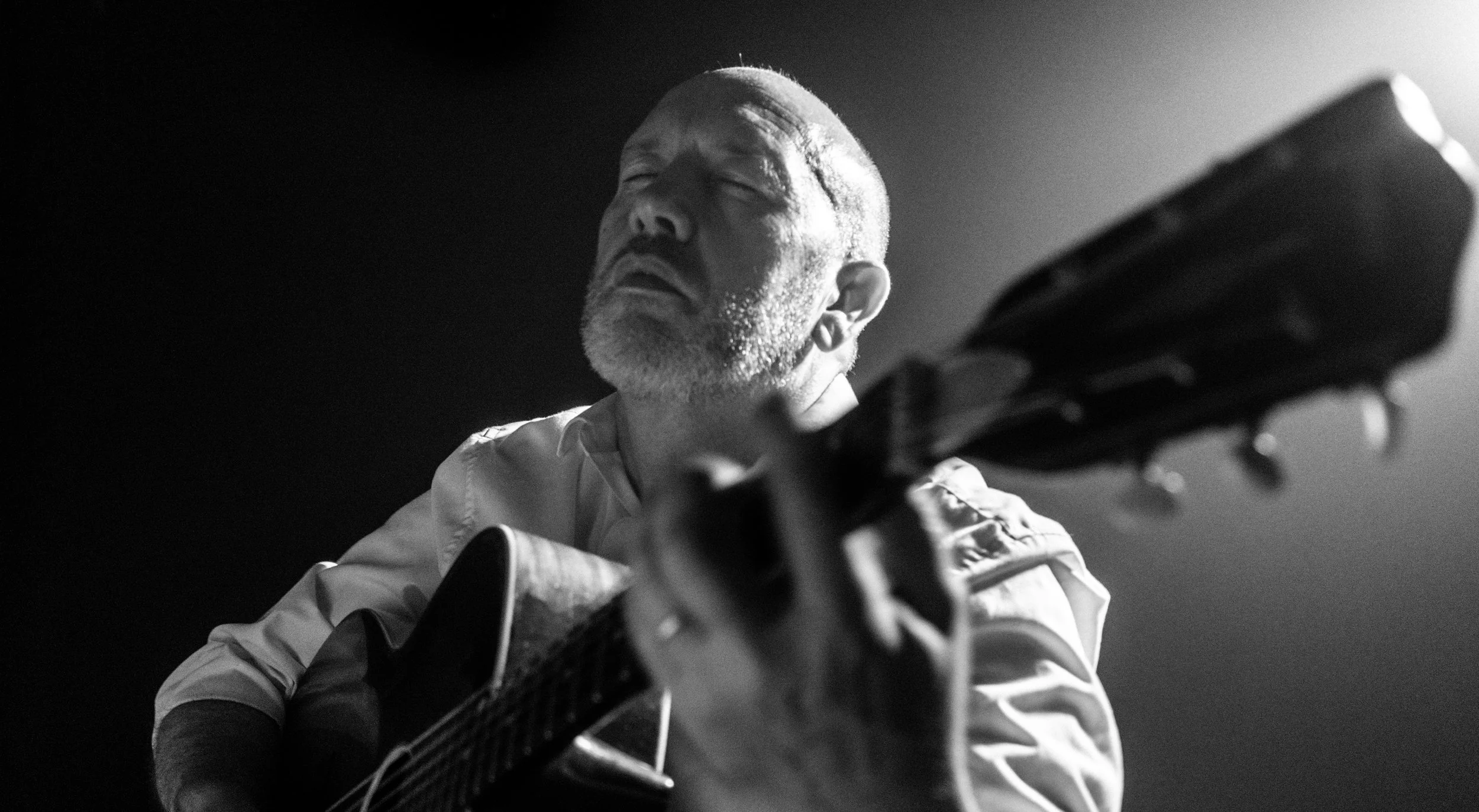 A black and white photo of a Gerry Tully a folk singer from Ireland. The photo was created by Robert Tully. 2017.