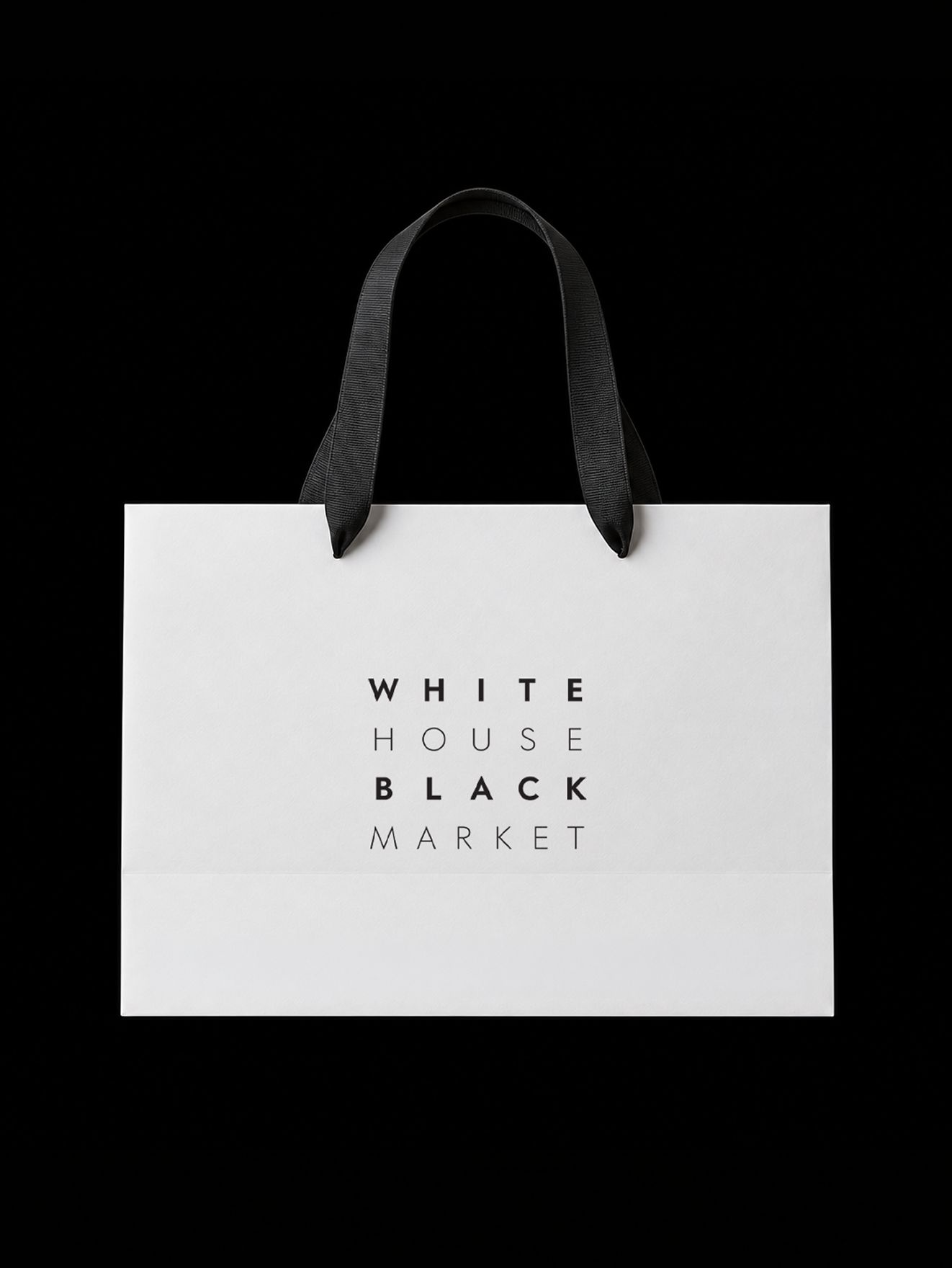 White shopping bag with black handles against a black background, with the words 'WHITE', 'HOUSE', 'BLACK', 'MARKET' printed on it.