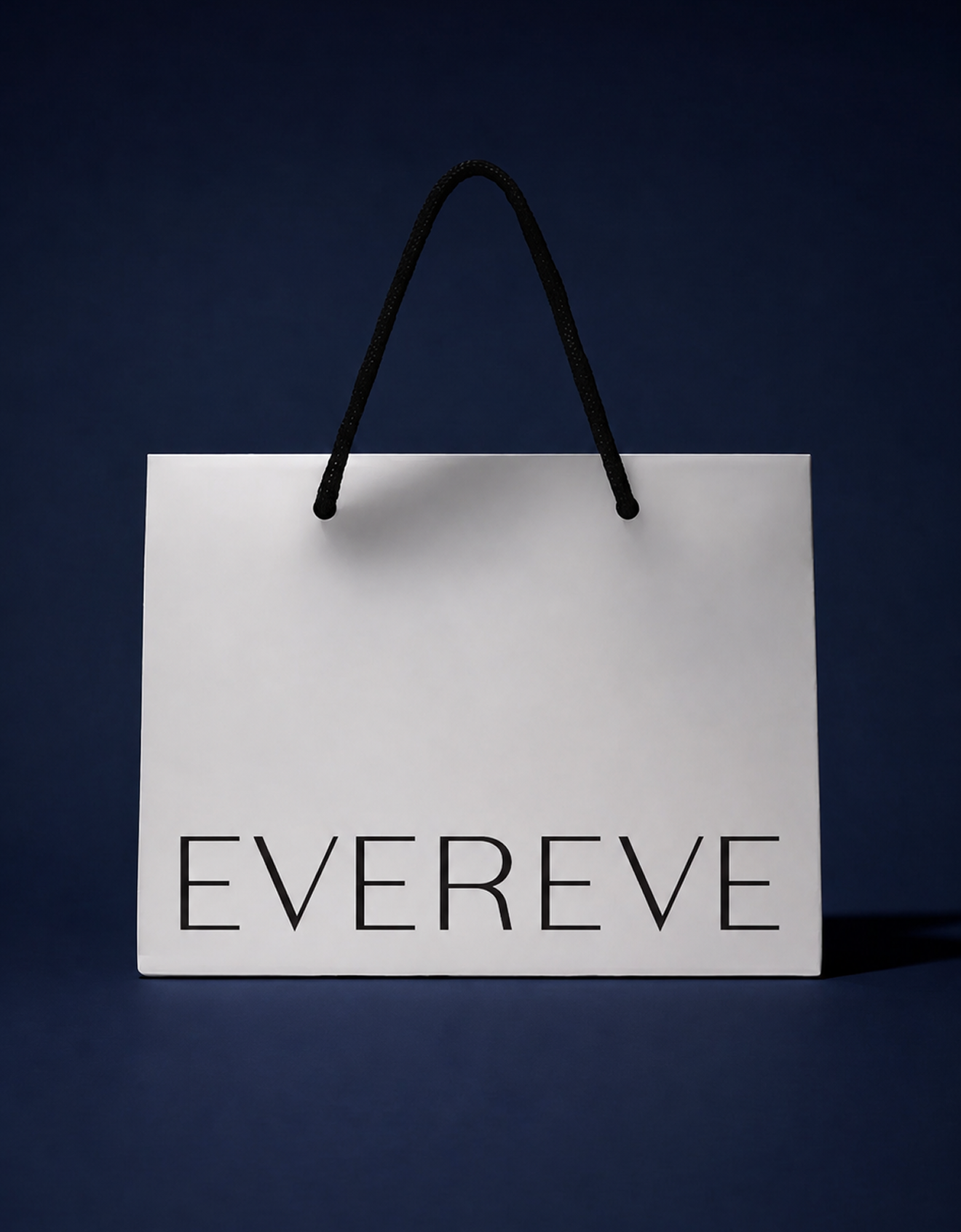 A white shopping bag with black handles hanging against a dark blue background. The bag has the words "EVER EVE" printed on it.