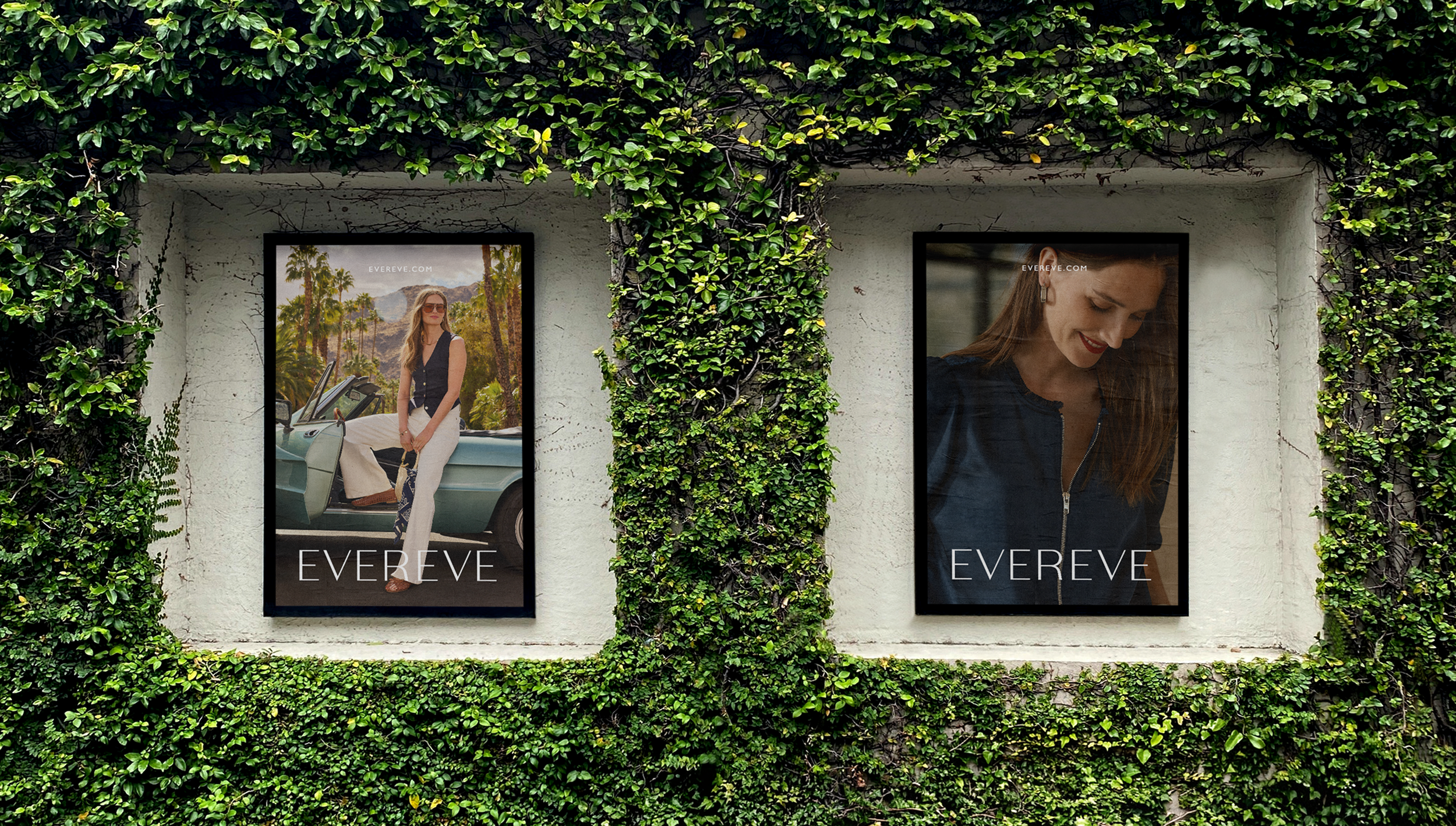 Two fashion posters displayed on a wall surrounded by green ivy, featuring women in stylish outfits.