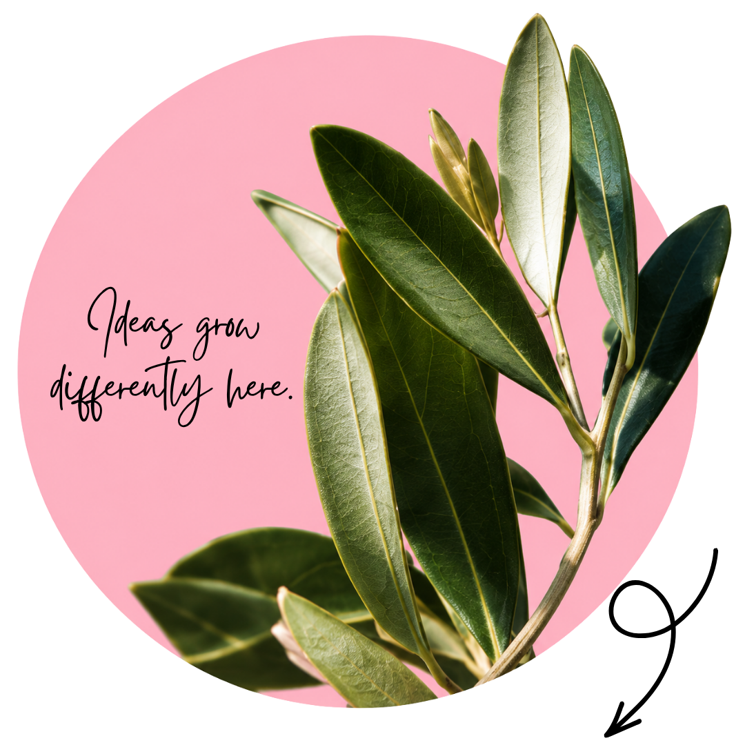 A pink circle with a branch of olive tree leaves and the text "Ideas grow differently here" written in black cursive.