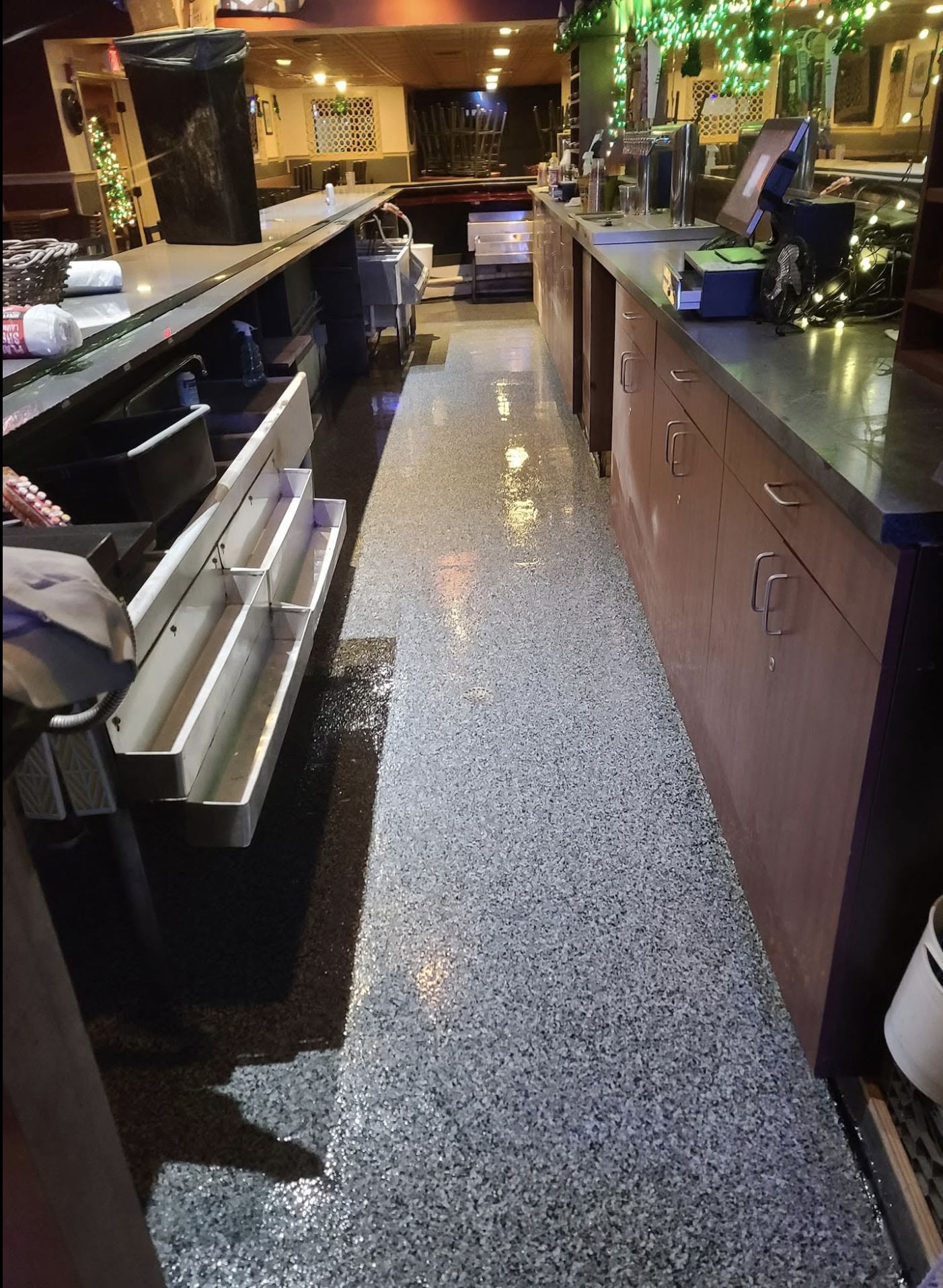 Fully customized epoxy floor behind bar.