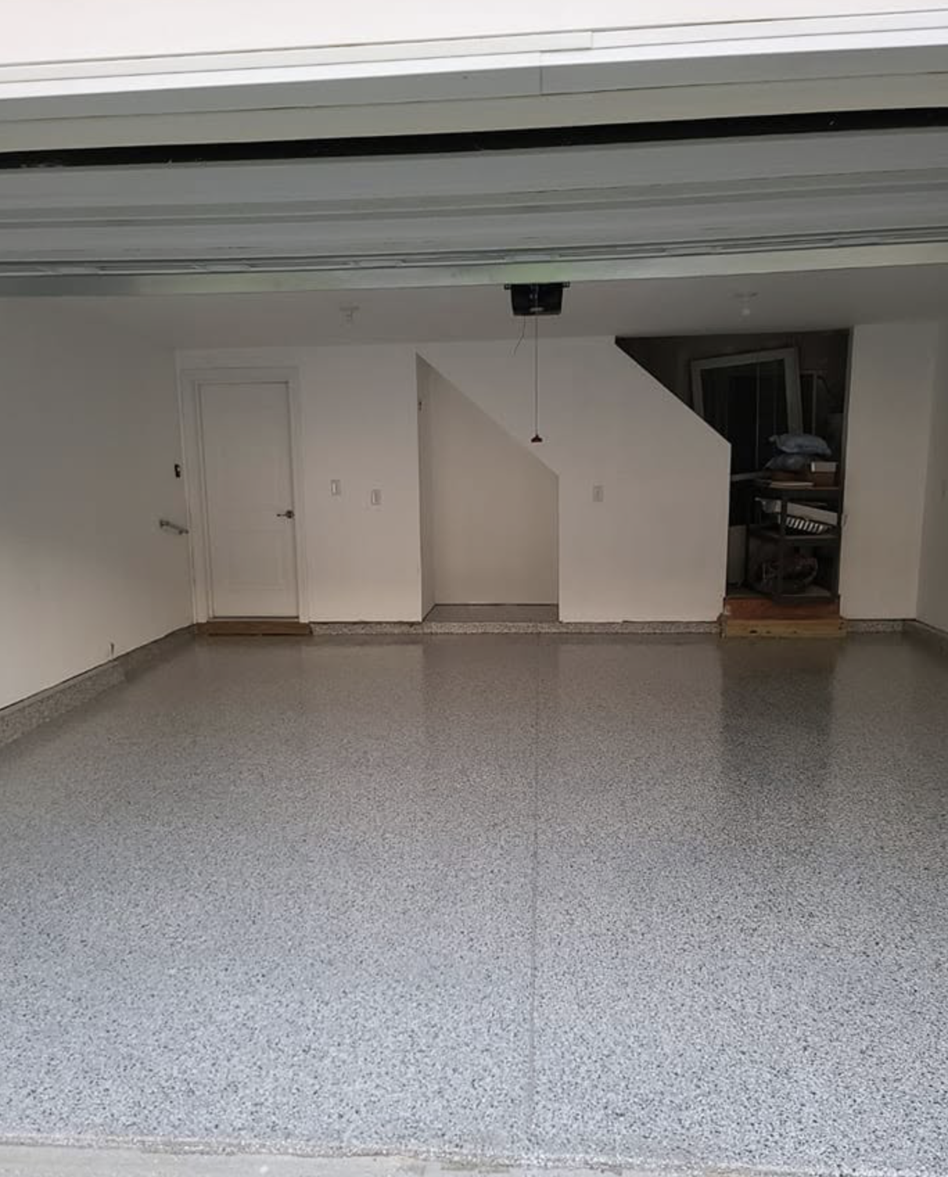 Empty garage with custom epoxy floor.