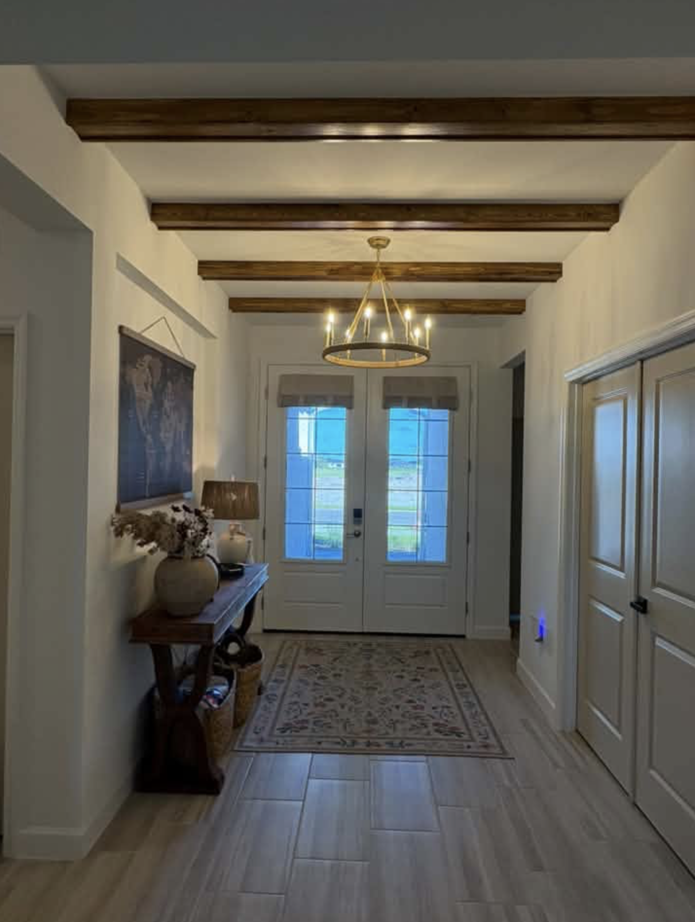 Entryway with wooden ceiling beams.