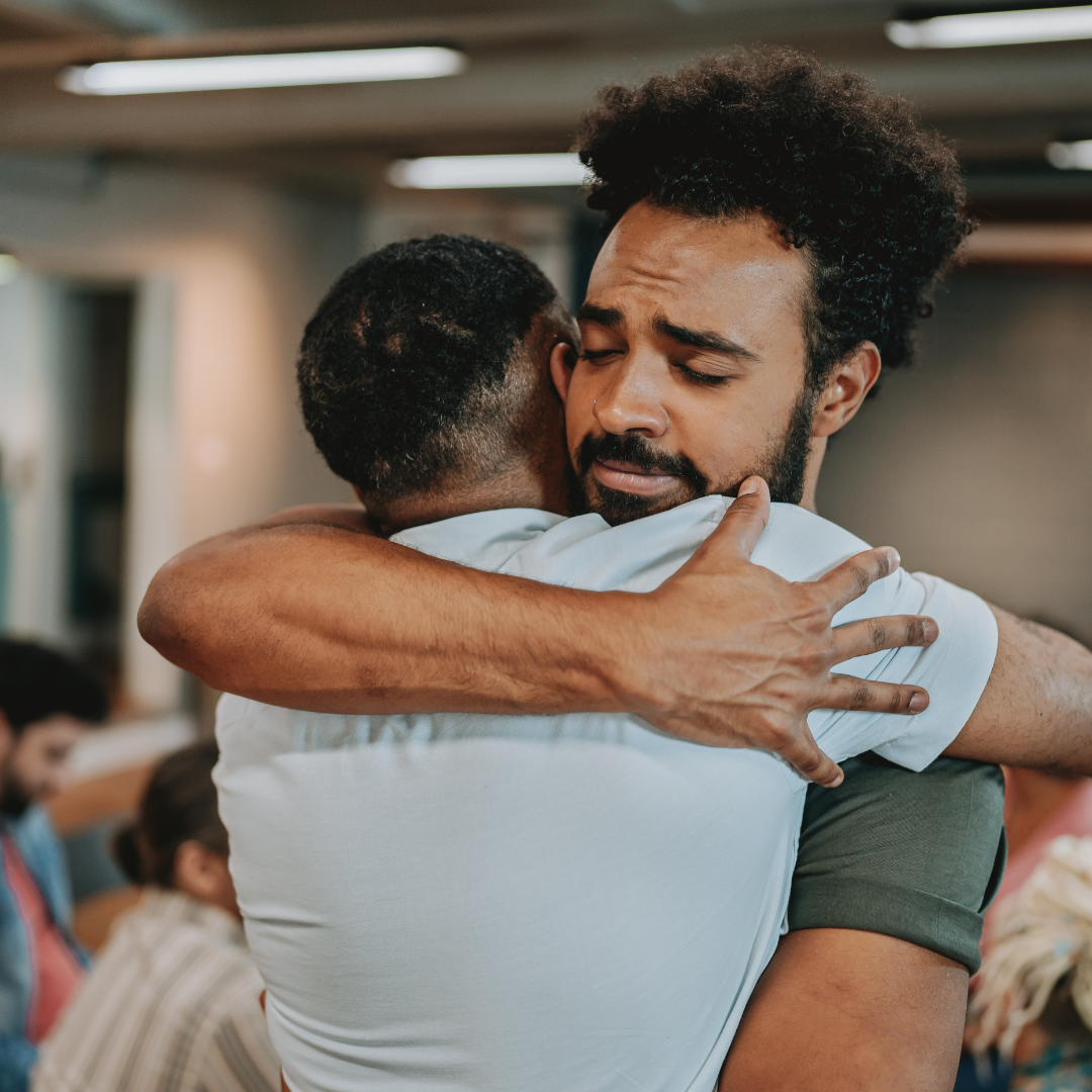 man hugging a male family member