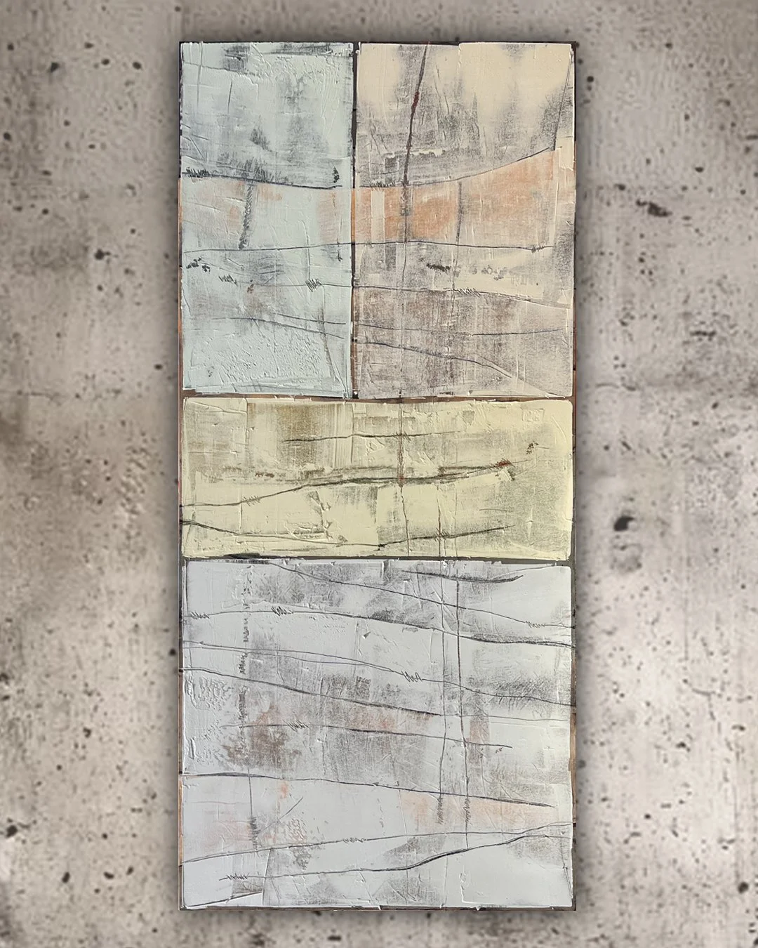 Abstract painting with four rectangular sections in pastel shades of blue, yellow, beige, and white, featuring textured and cracked surfaces.