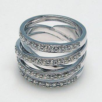 Wide silver-tone ring with overlapping polished bands and rows of clear stones.