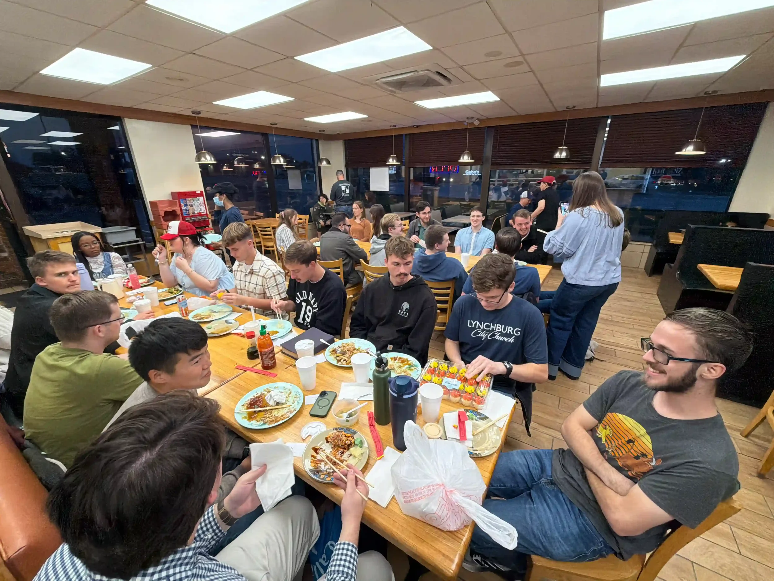 picture of church people eating food out at love feast