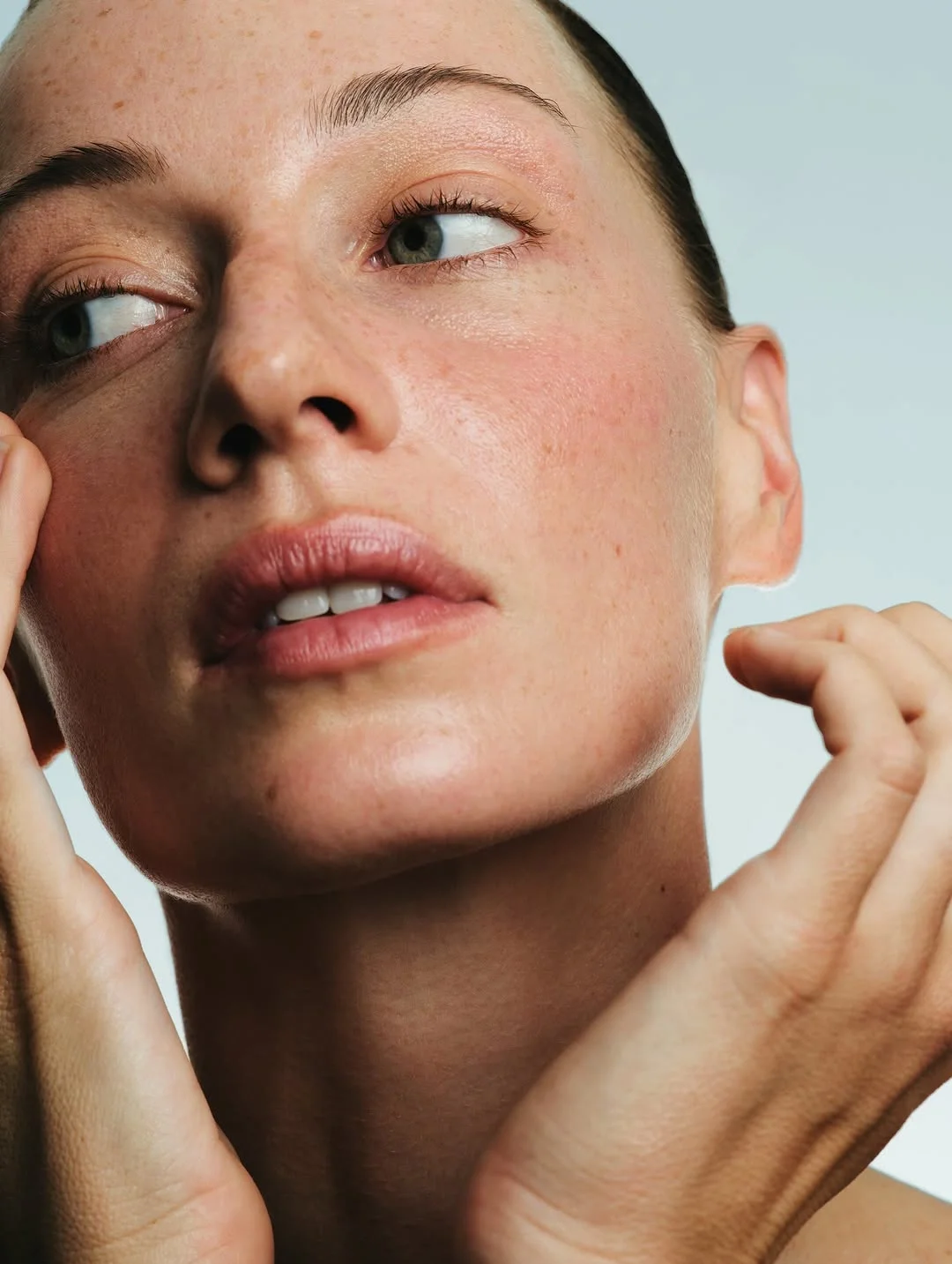 Close-up of a woman's face with visible skin texture and glow resulting from medical aesthetics treatment.