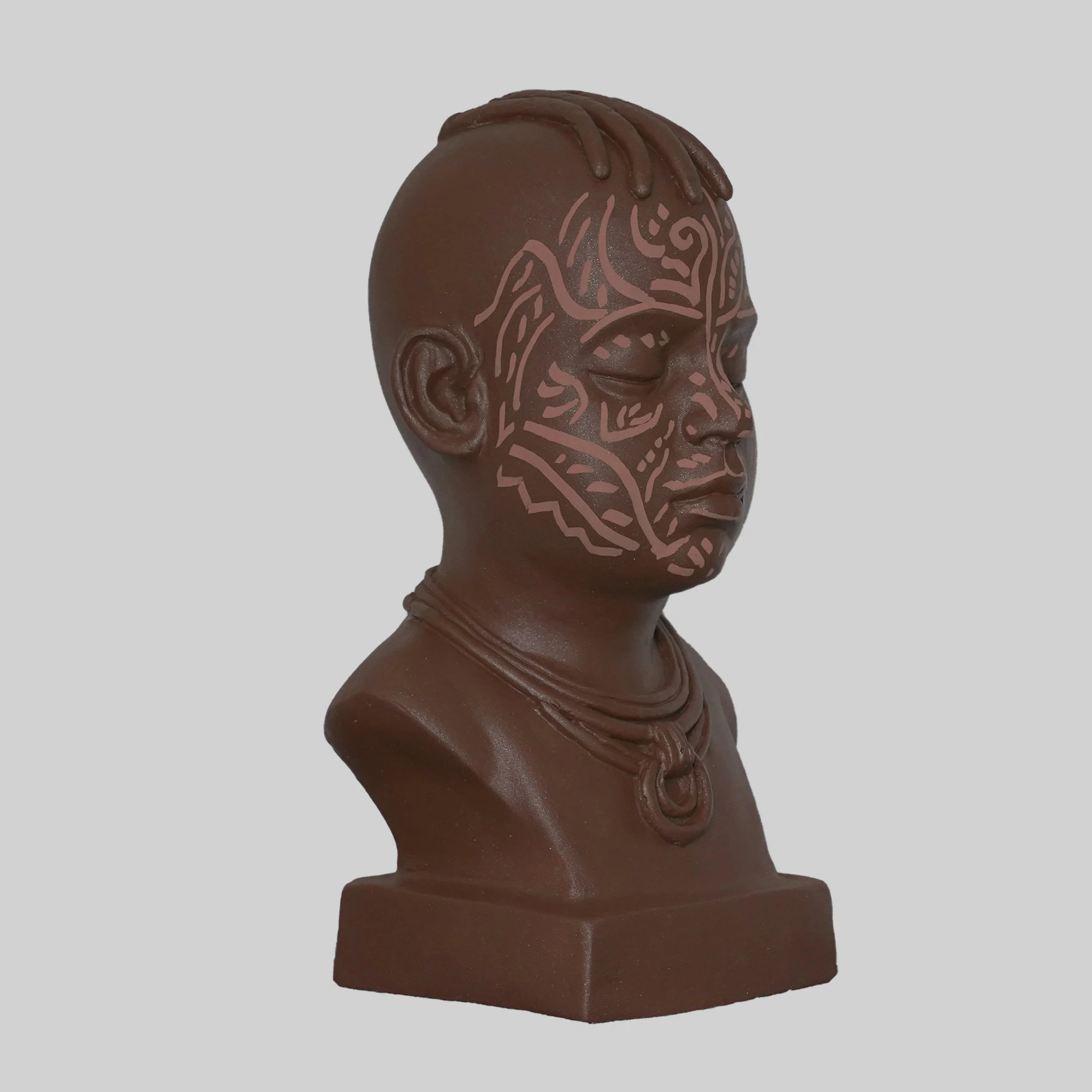 Resin sculpture finished with acrylic paint by Stanley Onah titled Sculpture IV (2025) of a child's head with intricate line designs on the forehead and face.