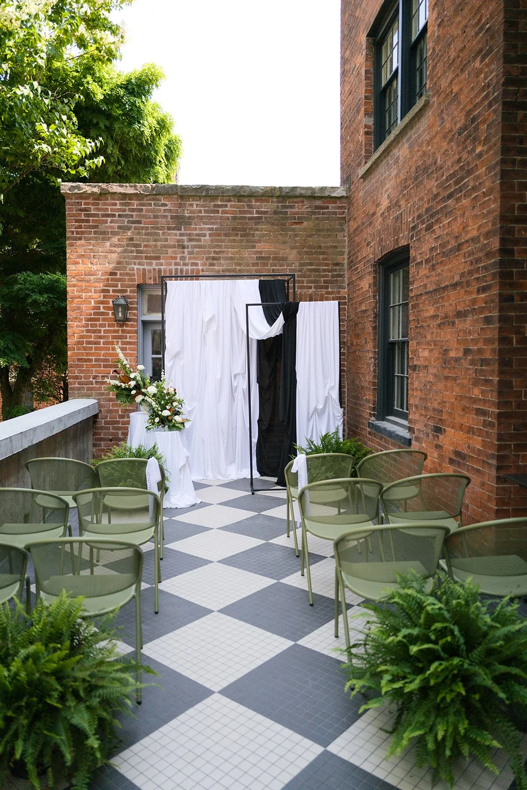 Outdoor wedding ceremony setup with chairs facing a small decorated altar.