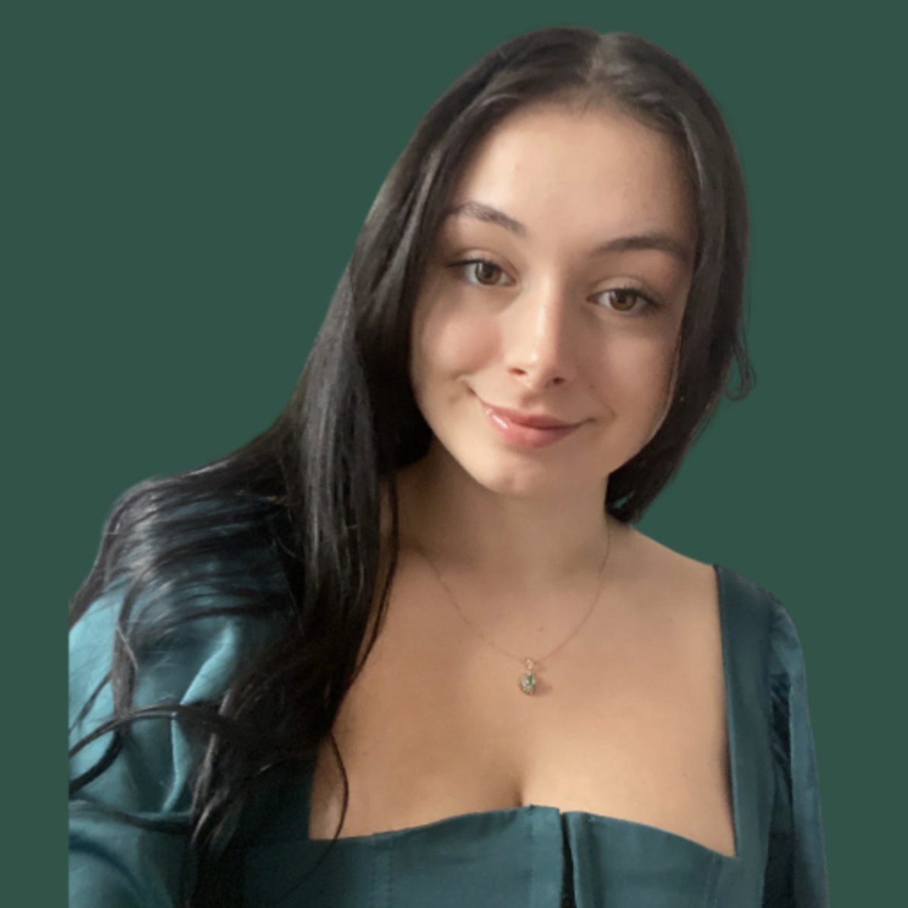 A woman, professional ghostwriter and book editor with long black hair and light skin, smiling, wearing a teal satin dress and a delicate necklace with a pendant, against a dark green background.