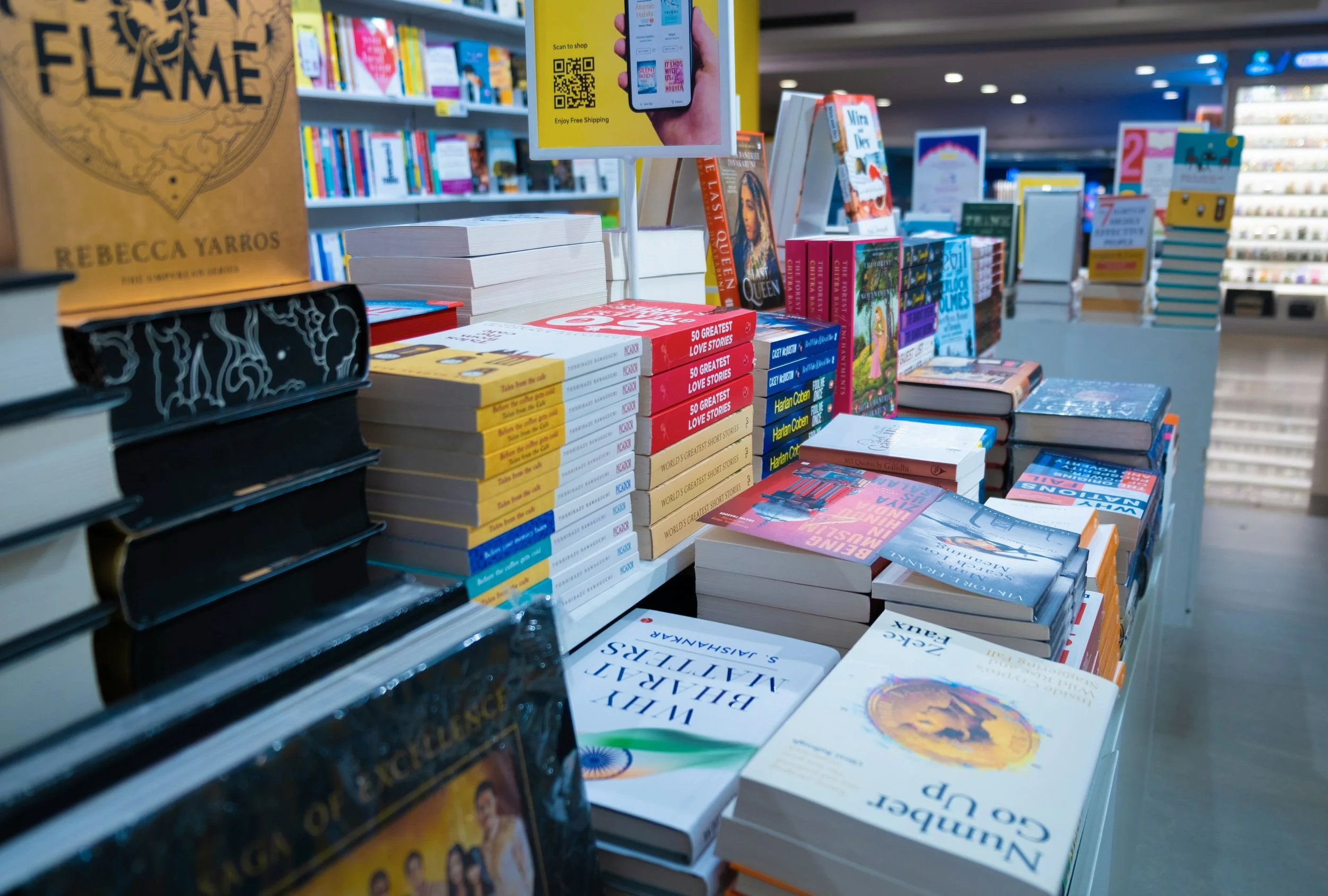 Various books displayed on a table in a bookstore, with some titles visible, demonstrating to an author how that when published, they could have a table of books in a bookstore as well.