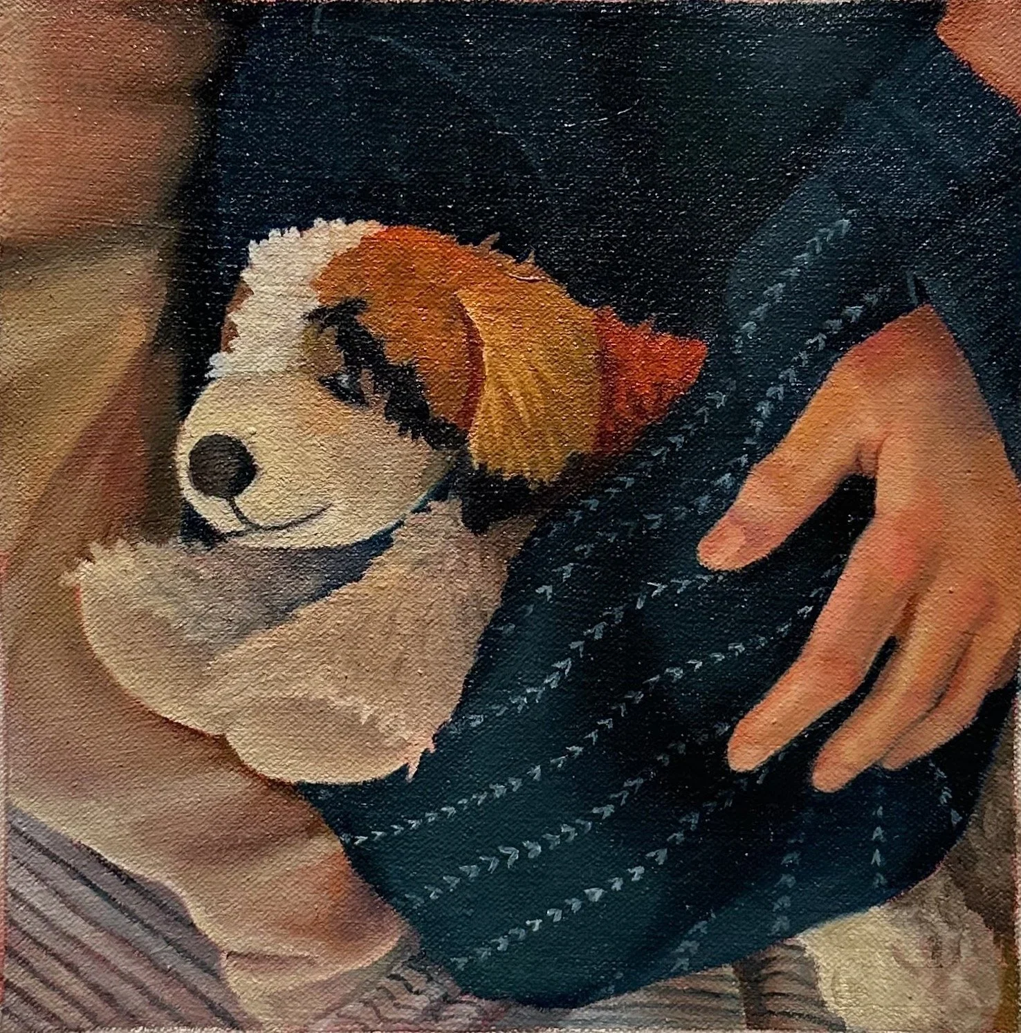 A person holding a small stuffed puppy with fluffy fur, the puppy's head resting in the person's hand and eyes closed, suggesting it is sleeping.