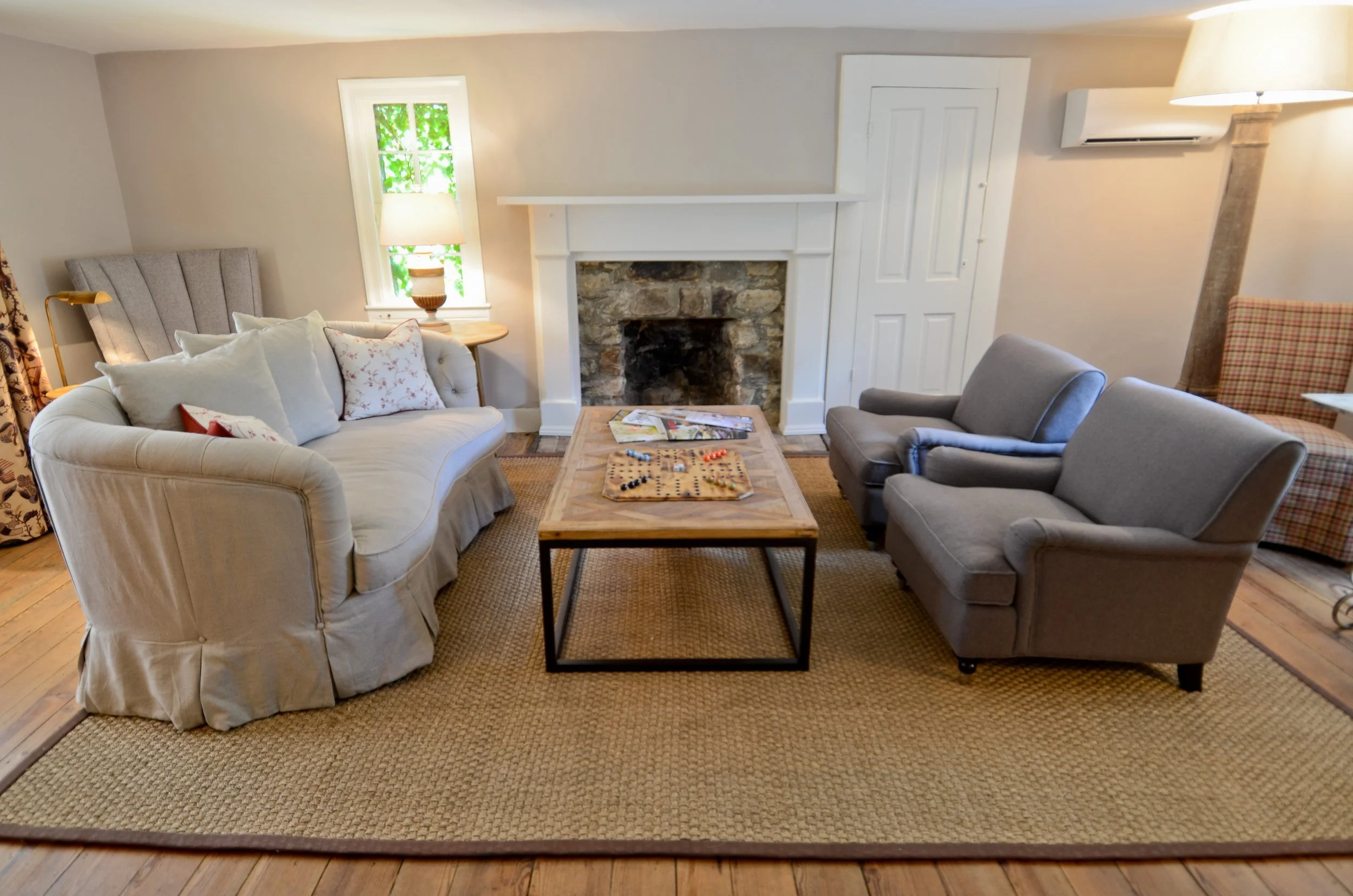 The Commons: slipcovered sofas around a stone fireplace.