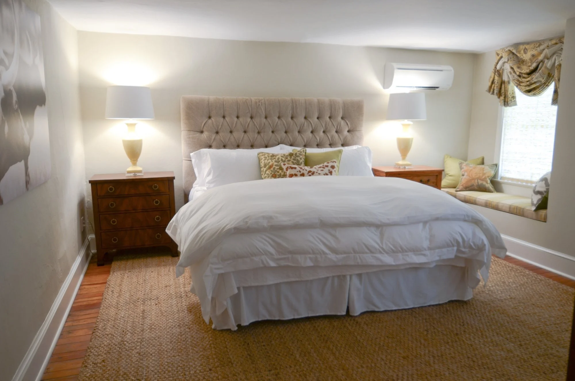 The Julep: a king bed with a linen headboard and a cushioned window seat.