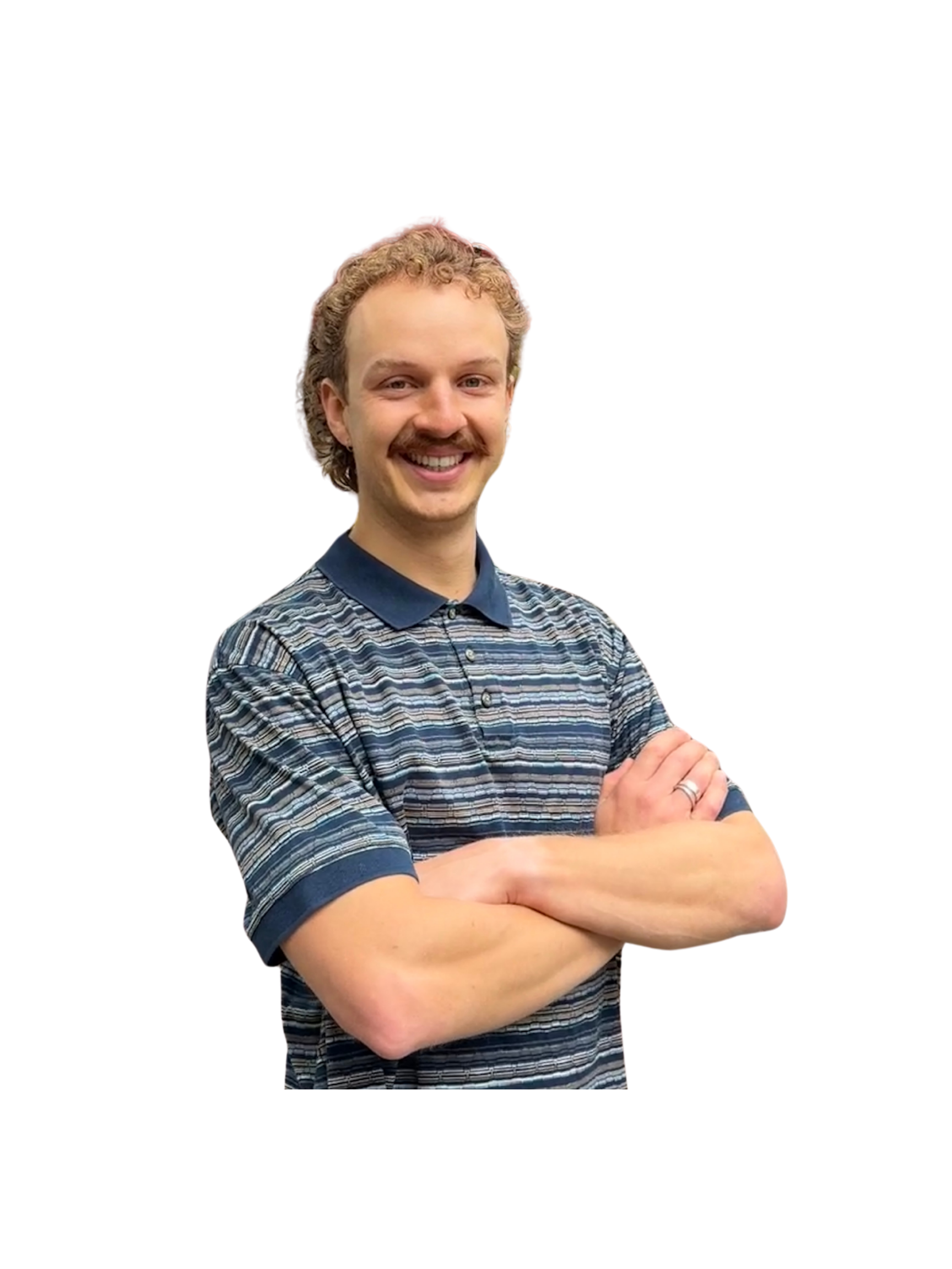 A man with curly blonde hair, a mustache, and a big smile, standing with arms crossed, wearing a striped polo shirt, against a black background with colorful overlay effects.