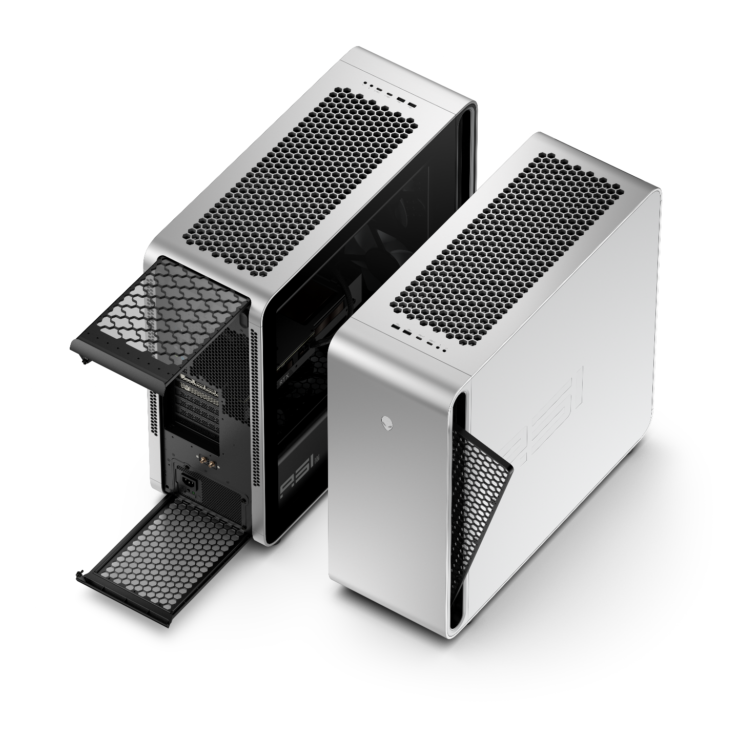 Two modern gaming desktop computers with silver and black designs, featuring large ventilation grids on top, with one tower displaying its internal components through an open side panel.