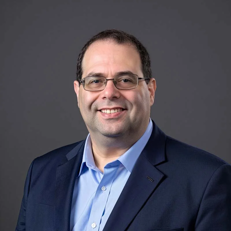Neal A. Levene in a suit jacket and blue shirt