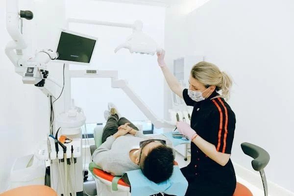 A dentist performing a dental procedure on a patient in a modern dental clinic.