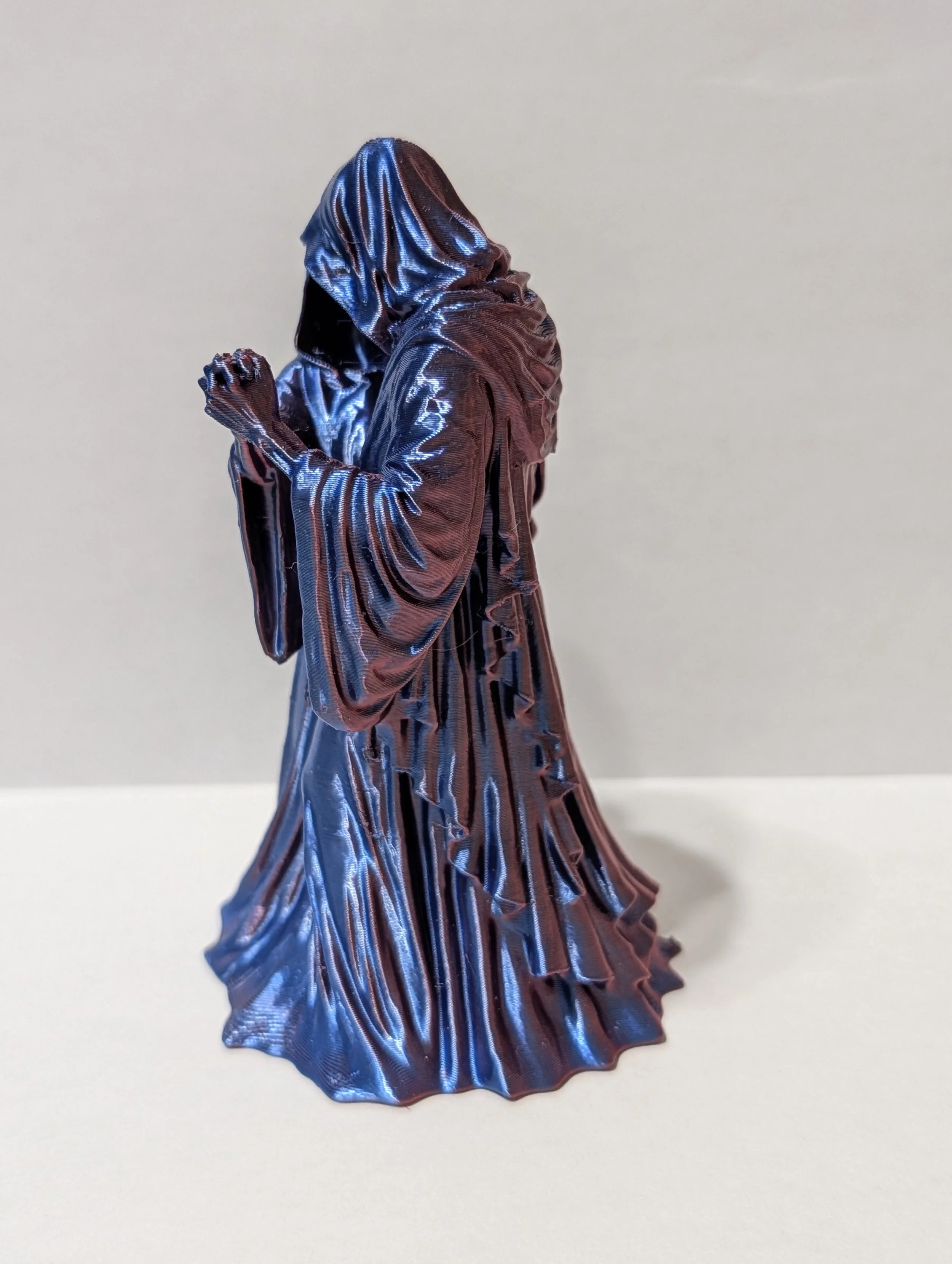 A detailed figurine of a woman in a flowing dress with a maelstrom of vibrant colors