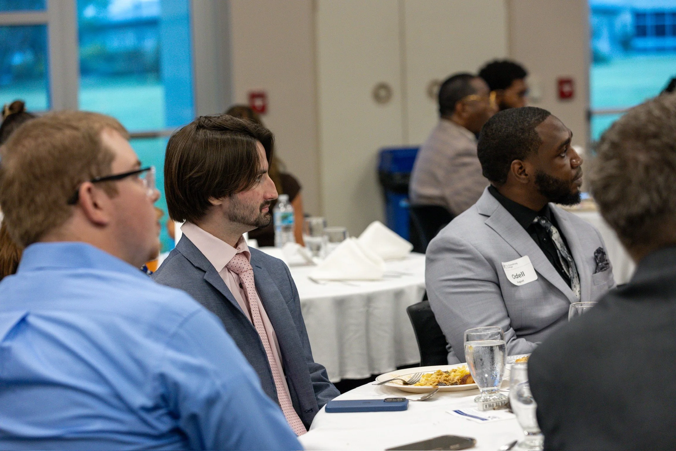 Ocean Fitts listening during a community dinner