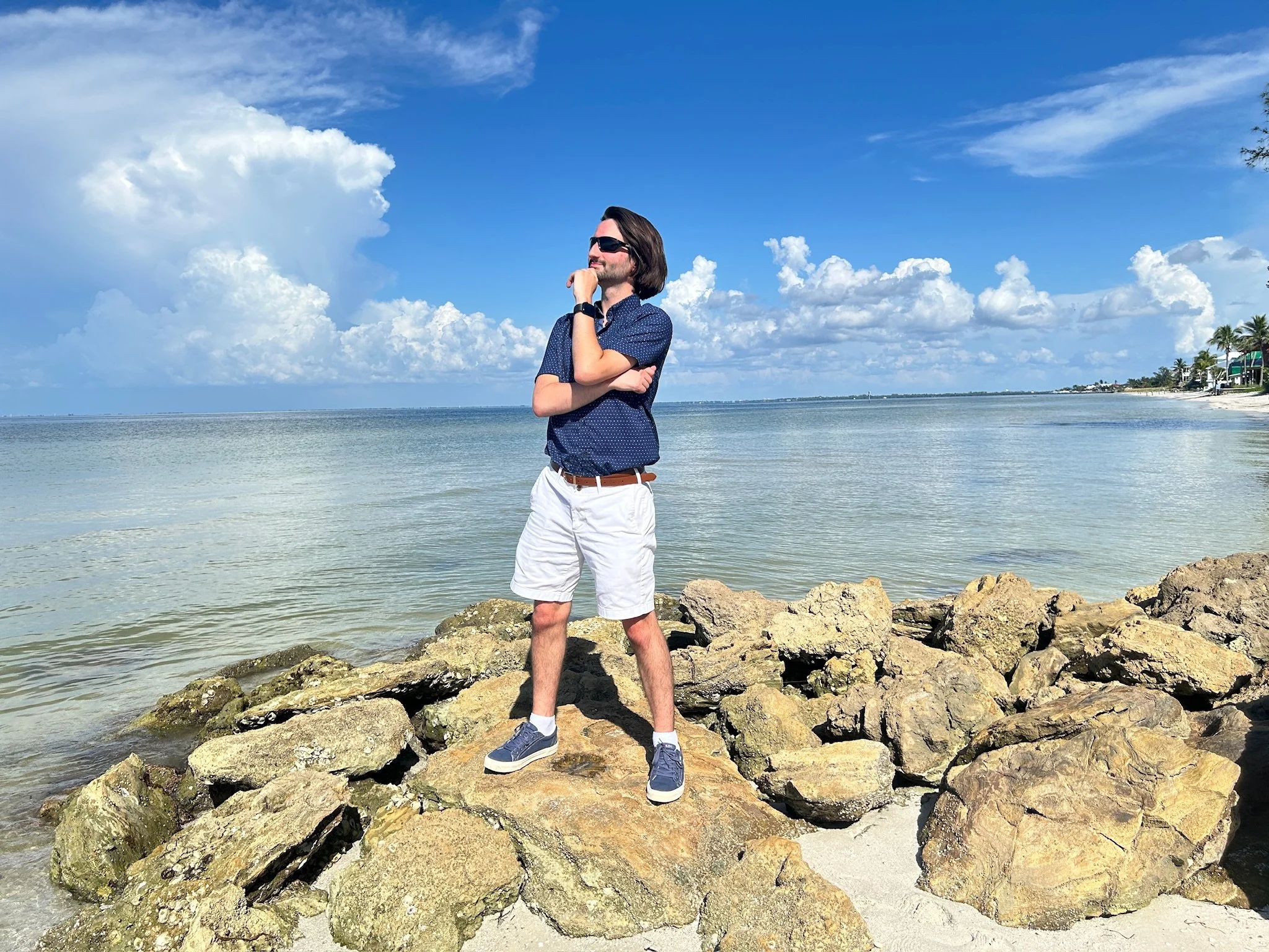 Ocean Fitts standing on the rocks along the water in Manatee County