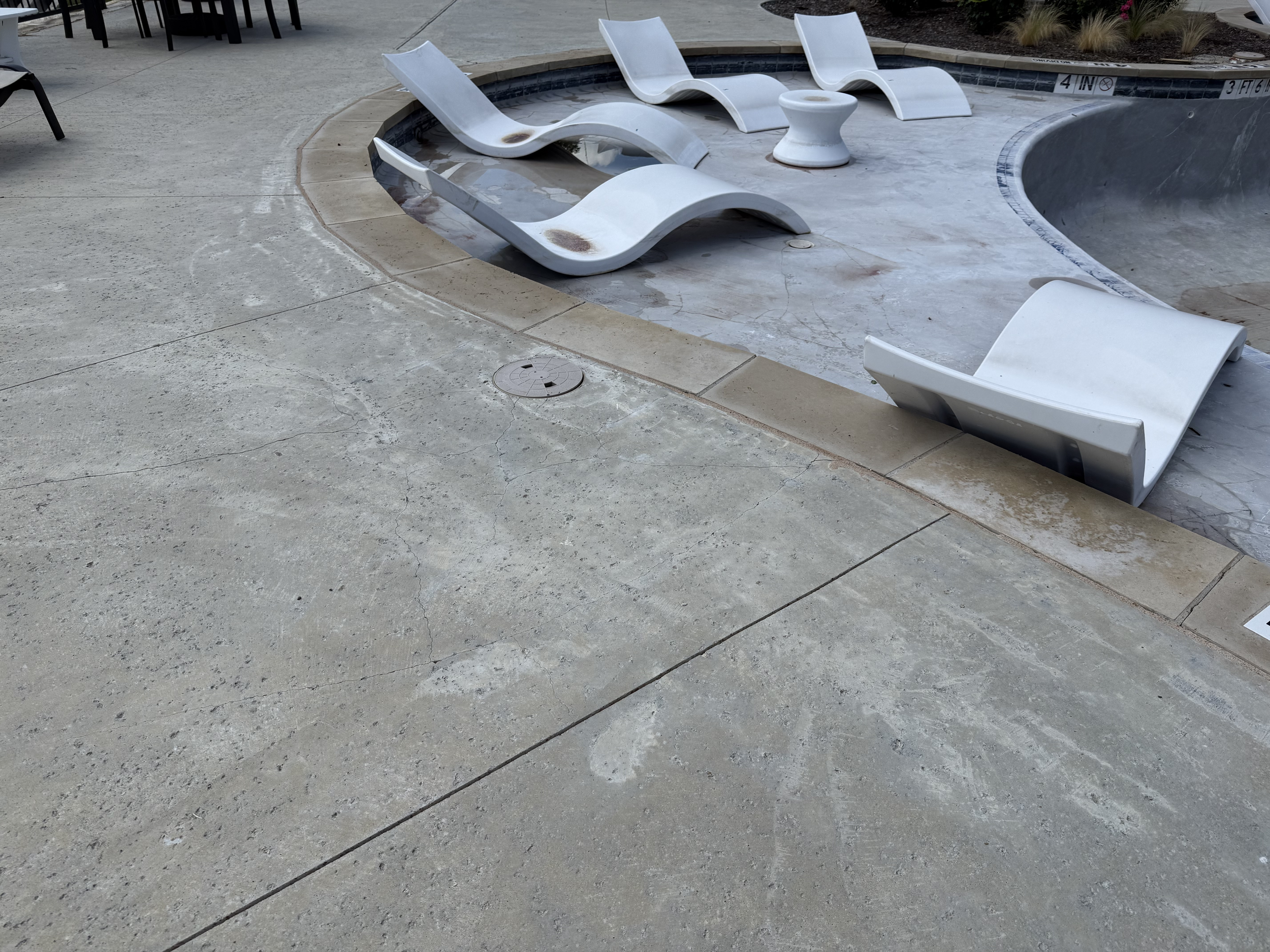 A pool sitting empty due to structrual damage and a current job Manifest pools is working on