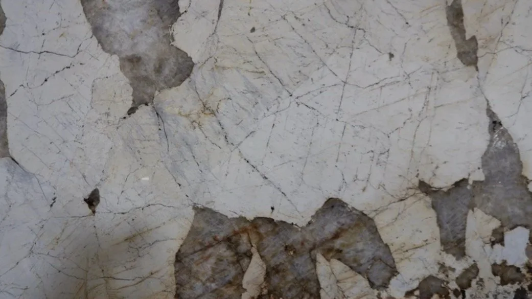 Close-up of a weathered wall with peeling paint and cracks.