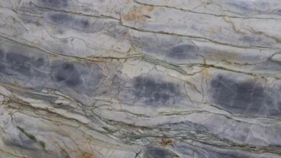 Close-up of a marble surface with gray, white, and gold veining patterns.