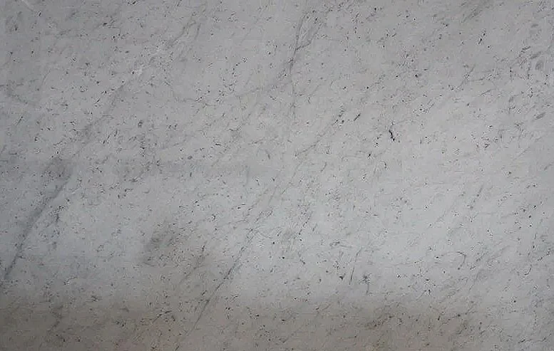 Close-up of a gray, textured surface with visible scratches and stains.
