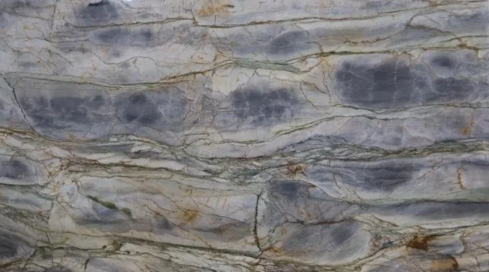 Close-up of a marble or stone surface with gray, white, and gold veining.
