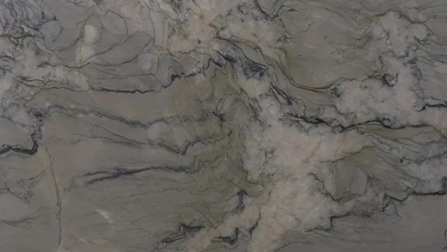Close-up of a marble surface with cream, gray, and black veining.