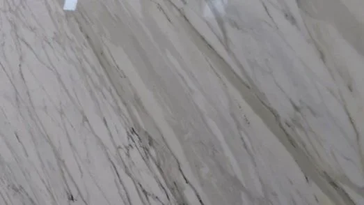 Close-up of a marbled surface with white, gray, and black streaks.