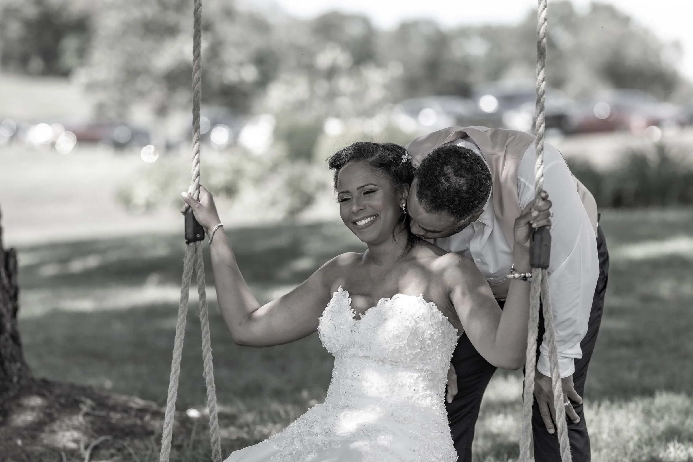 Danisha and Patrick sharing a joyful moment on a swing