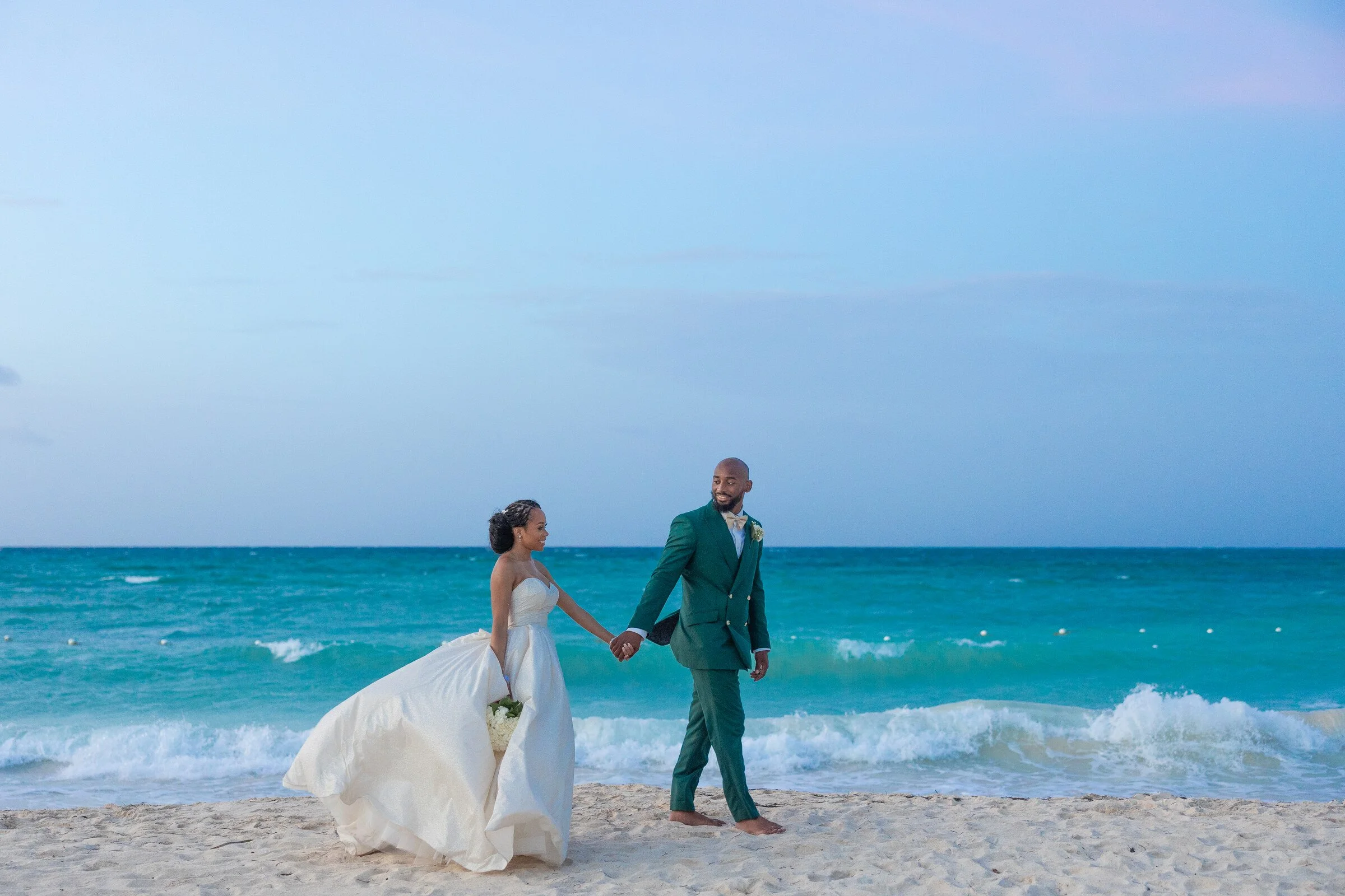 Ashley and Jahron walking together on the beach