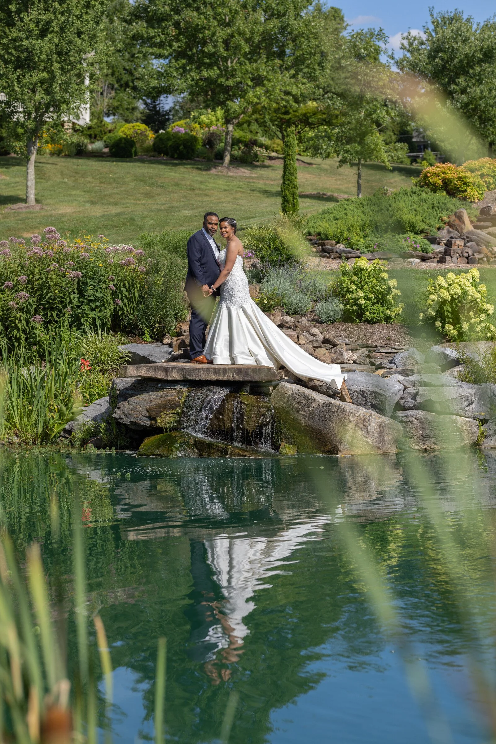 Danisha and Patrick reflected in the water at Glen Ellen Farm